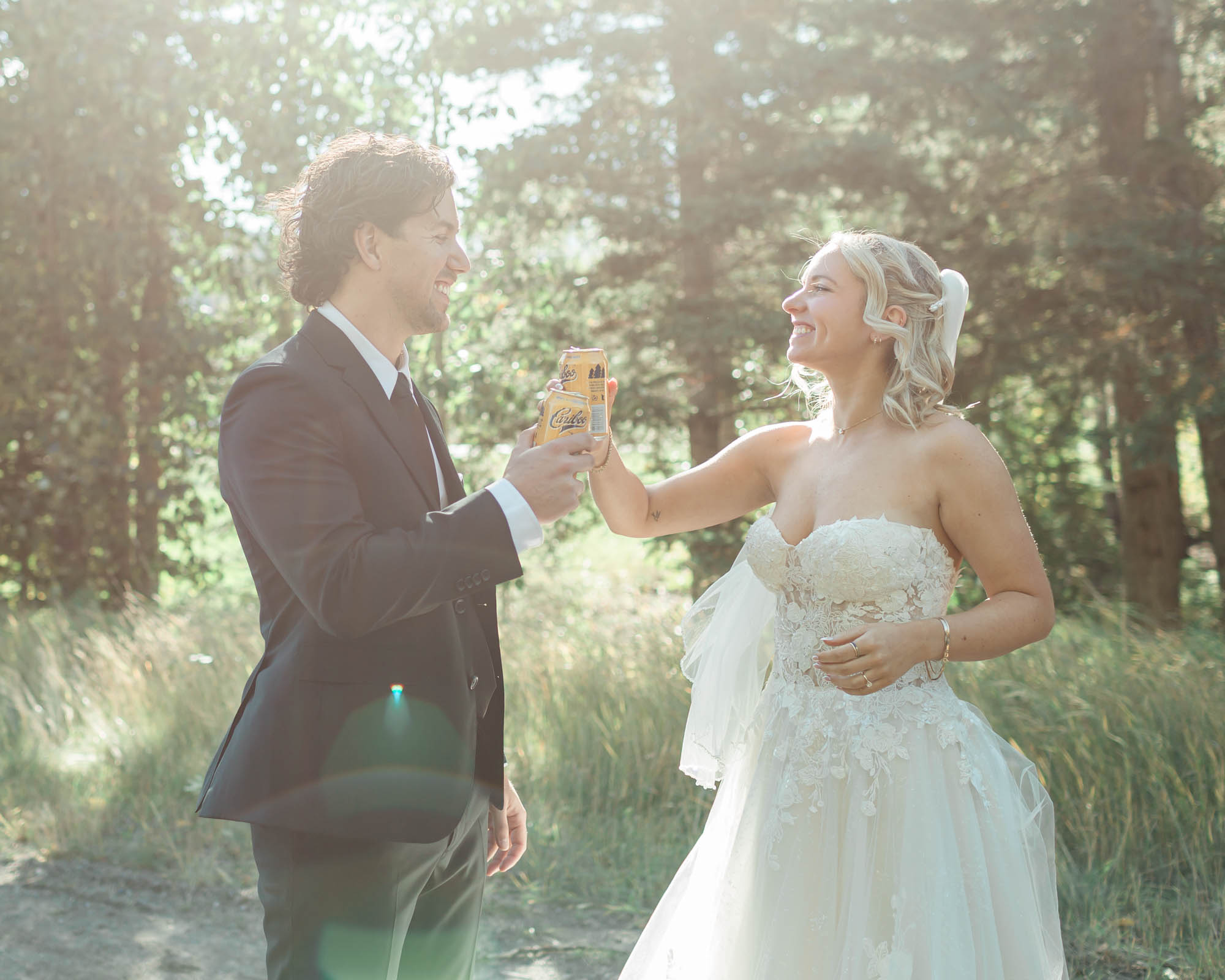 sarah and tyler cheers their beer for their banff elopement