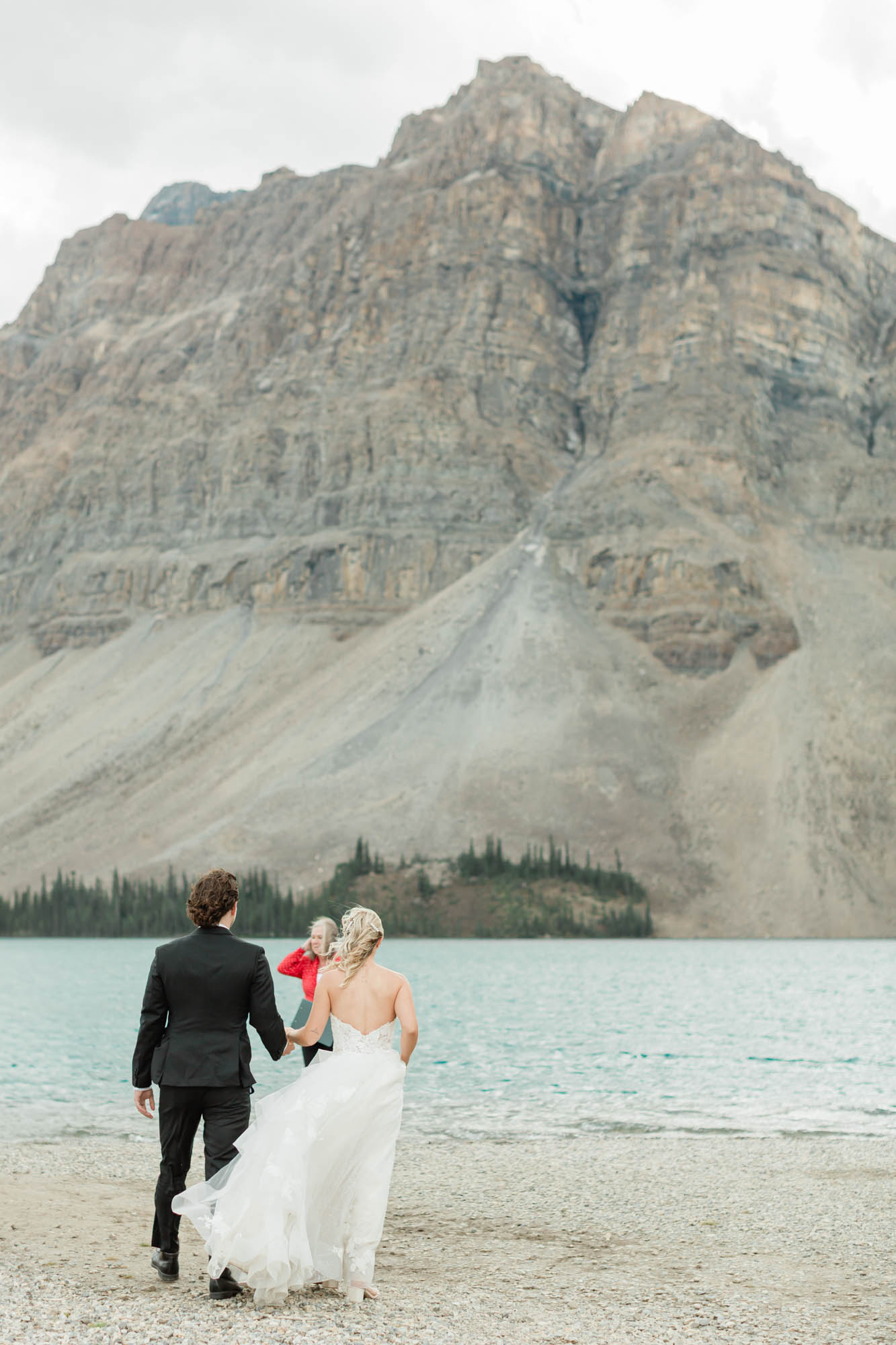 tyler and sarah walking to their ceremony bow lake for their summer banff elopement 