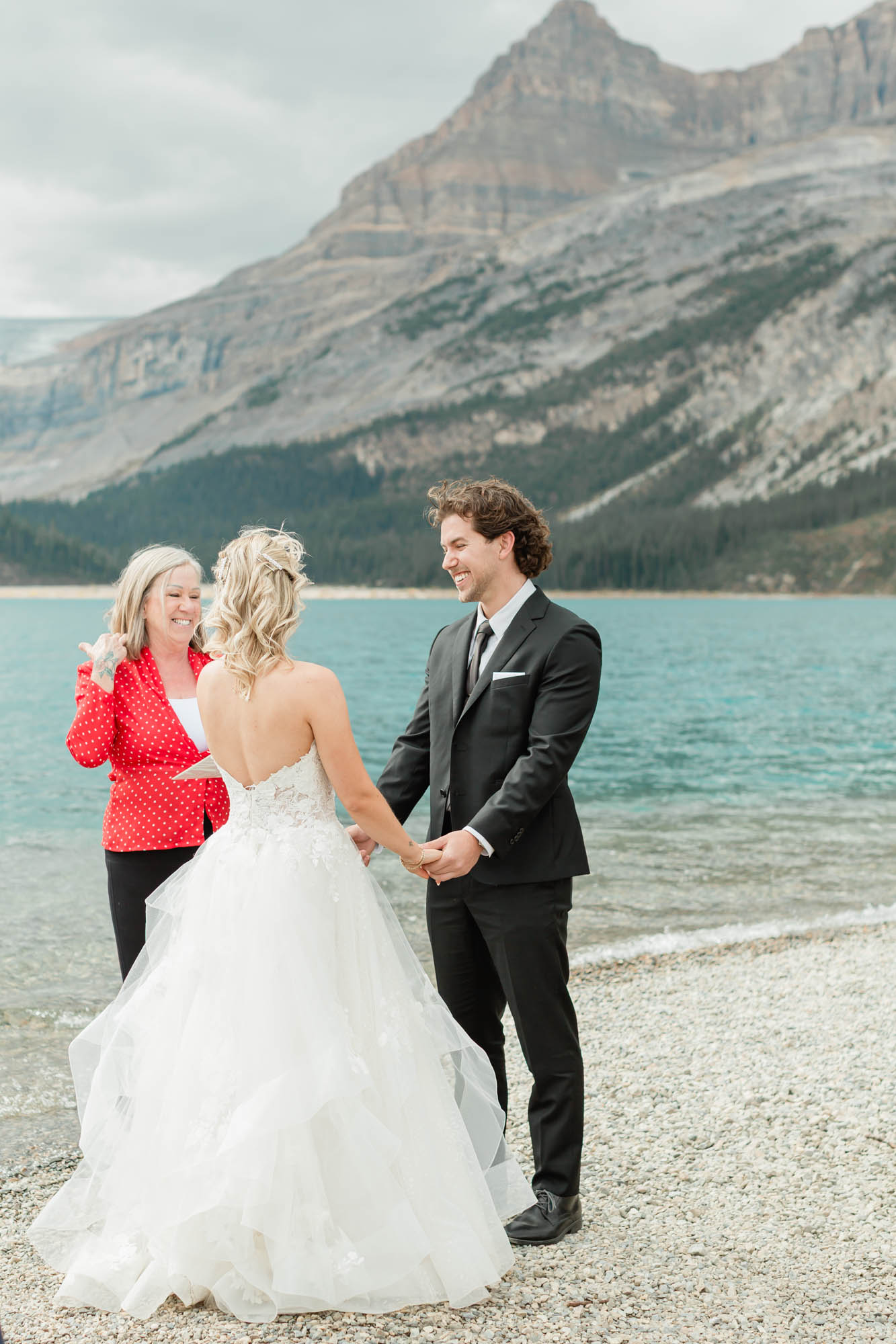 tyler and sarah exchanging vows at bow lake for their summer banff elopement 