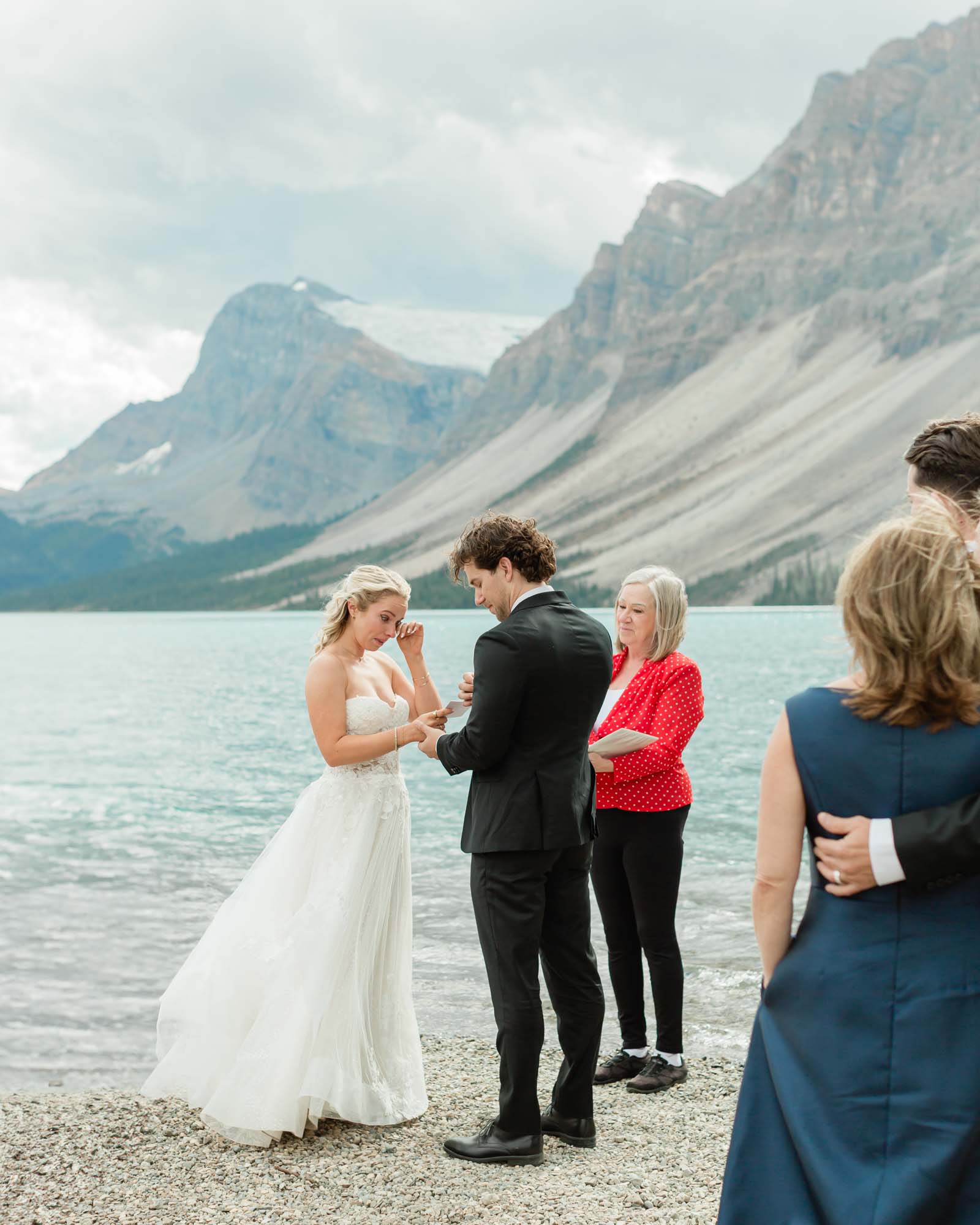 tyler and sarah exchanging vows at bow lake for their summer banff elopement 