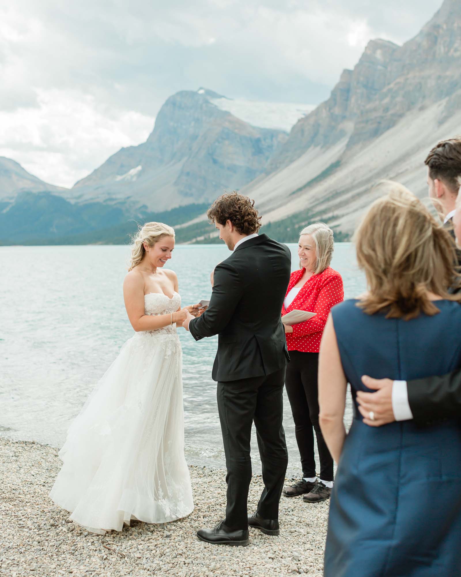 tyler and sarah exchanging vows at bow lake for their summer banff elopement 