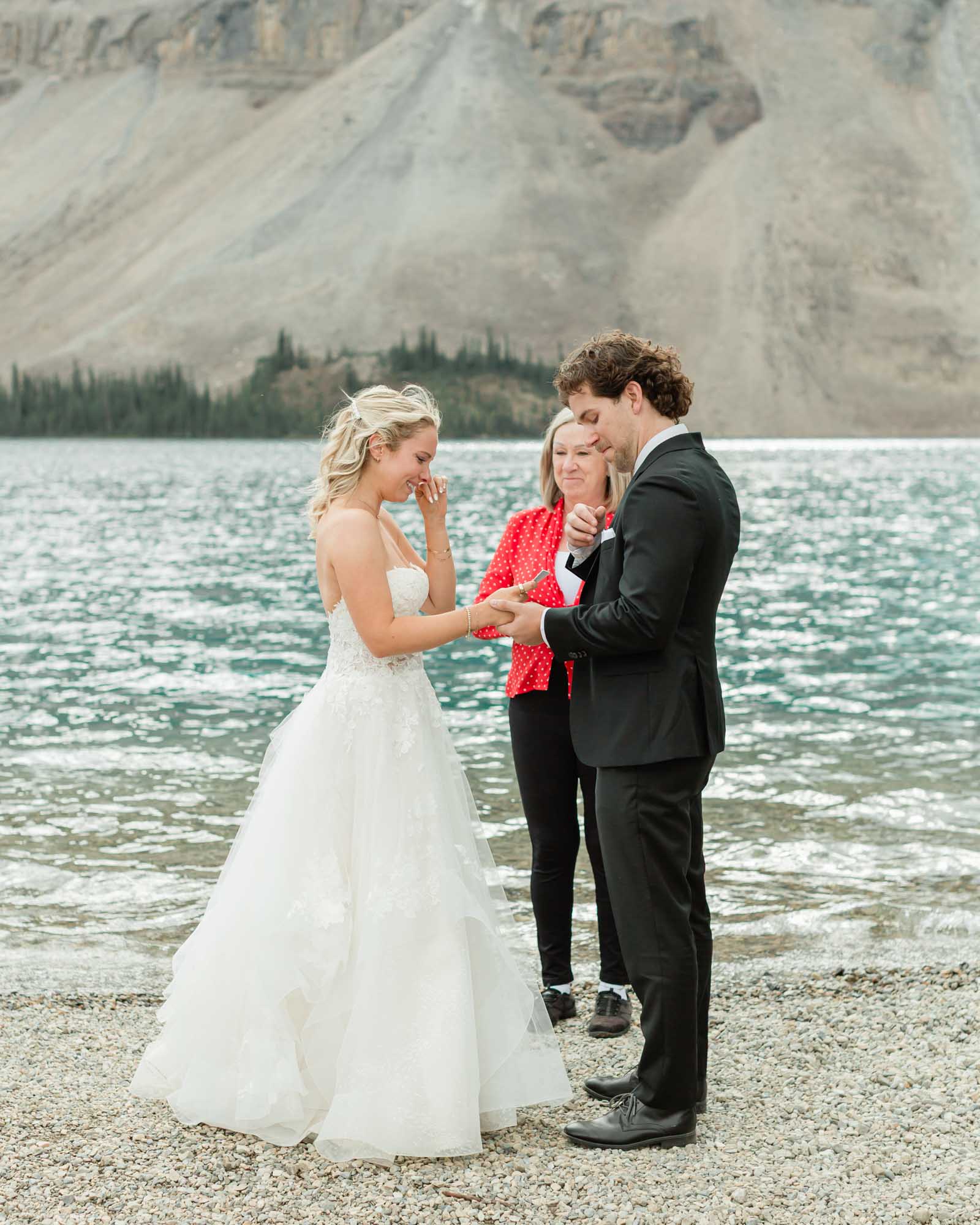 tyler and sarah exchanging vows at bow lake for their summer banff elopement 