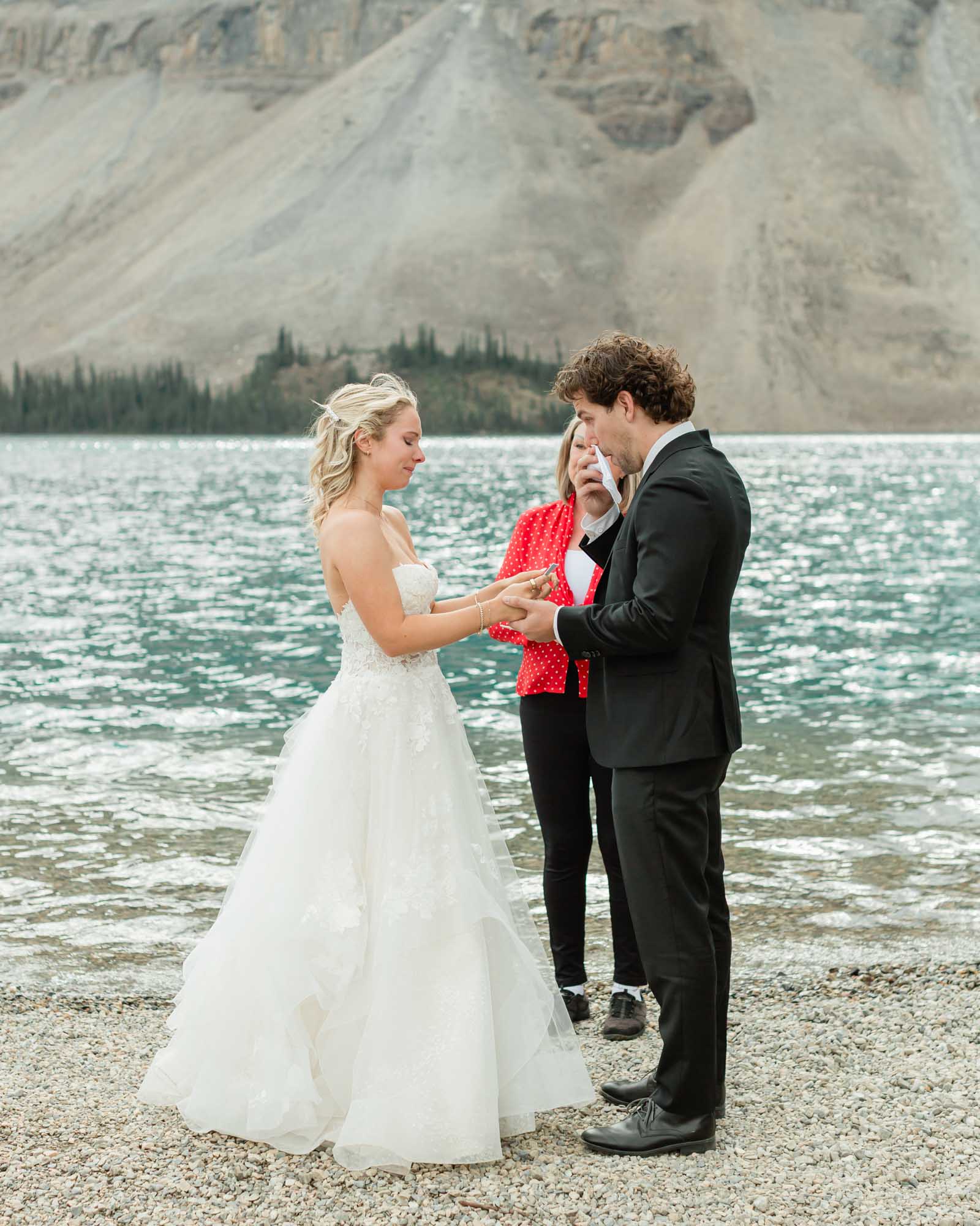tyler and sarah exchanging vows at bow lake for their summer banff elopement 