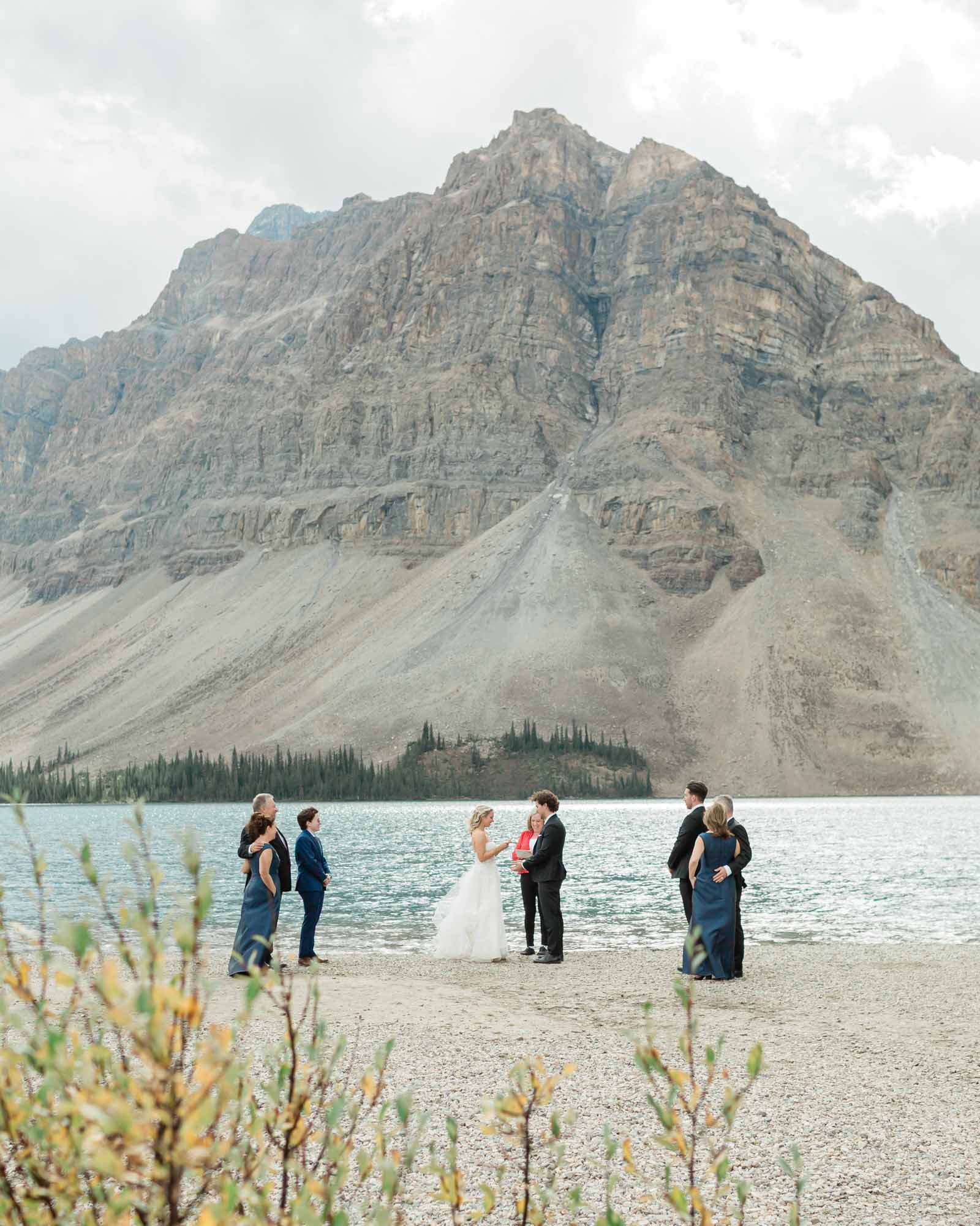 tyler and sarah exchanging vows at bow lake for their summer banff elopement 