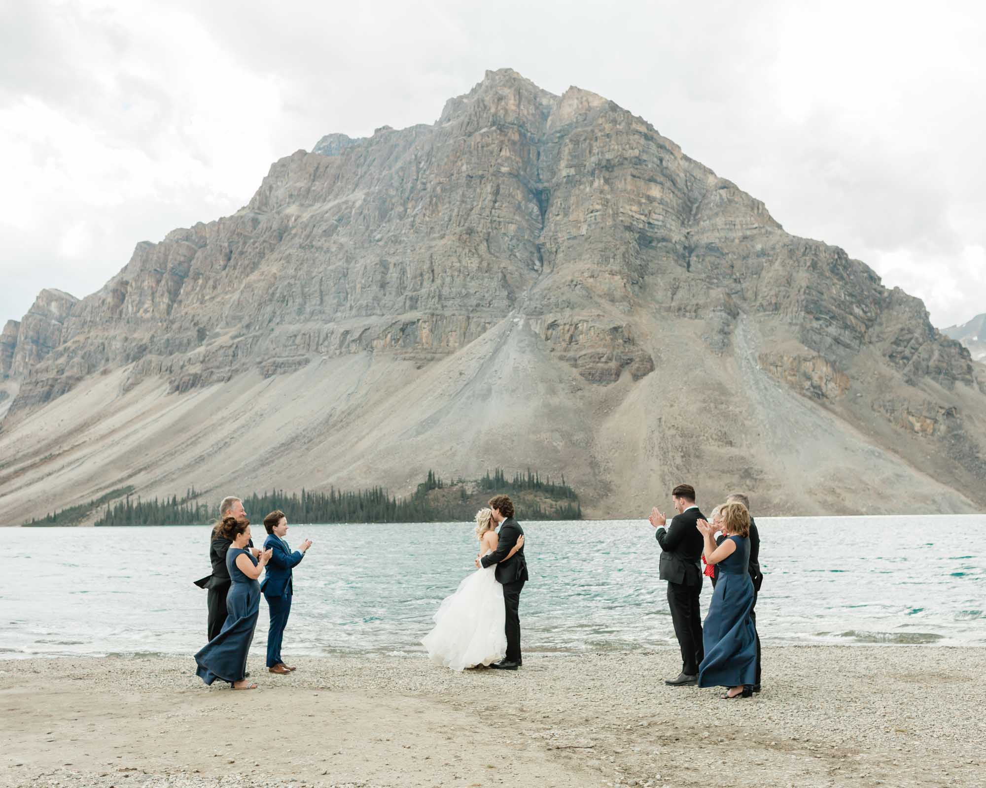 tyler and sarah kissing after their ceremony at bow lake for their summer banff elopement 