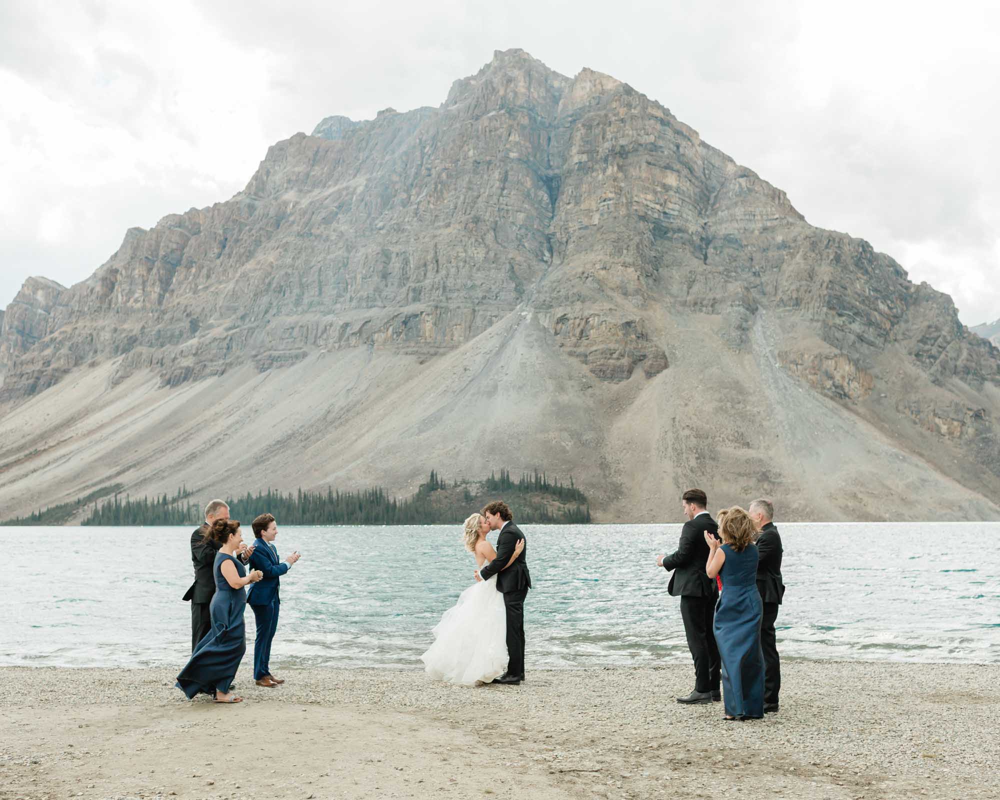 tyler and sarah kissing after their ceremony at bow lake for their summer banff elopement 