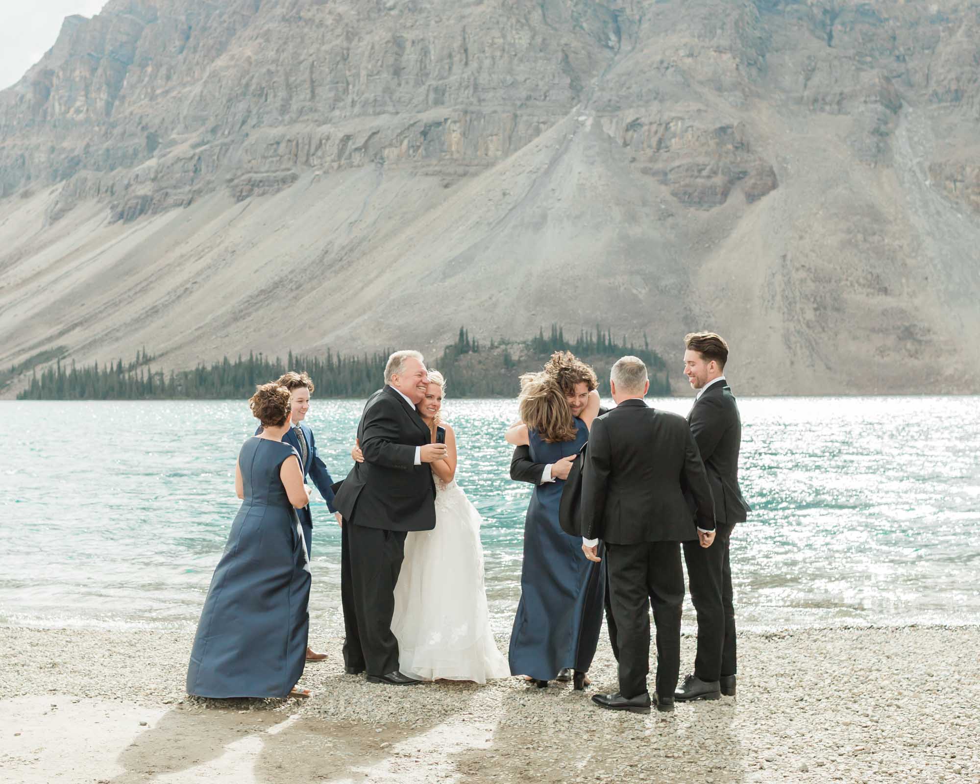 tyler, sarah and guests celebrating together after their ceremony at bow lake for their summer banff elopement 