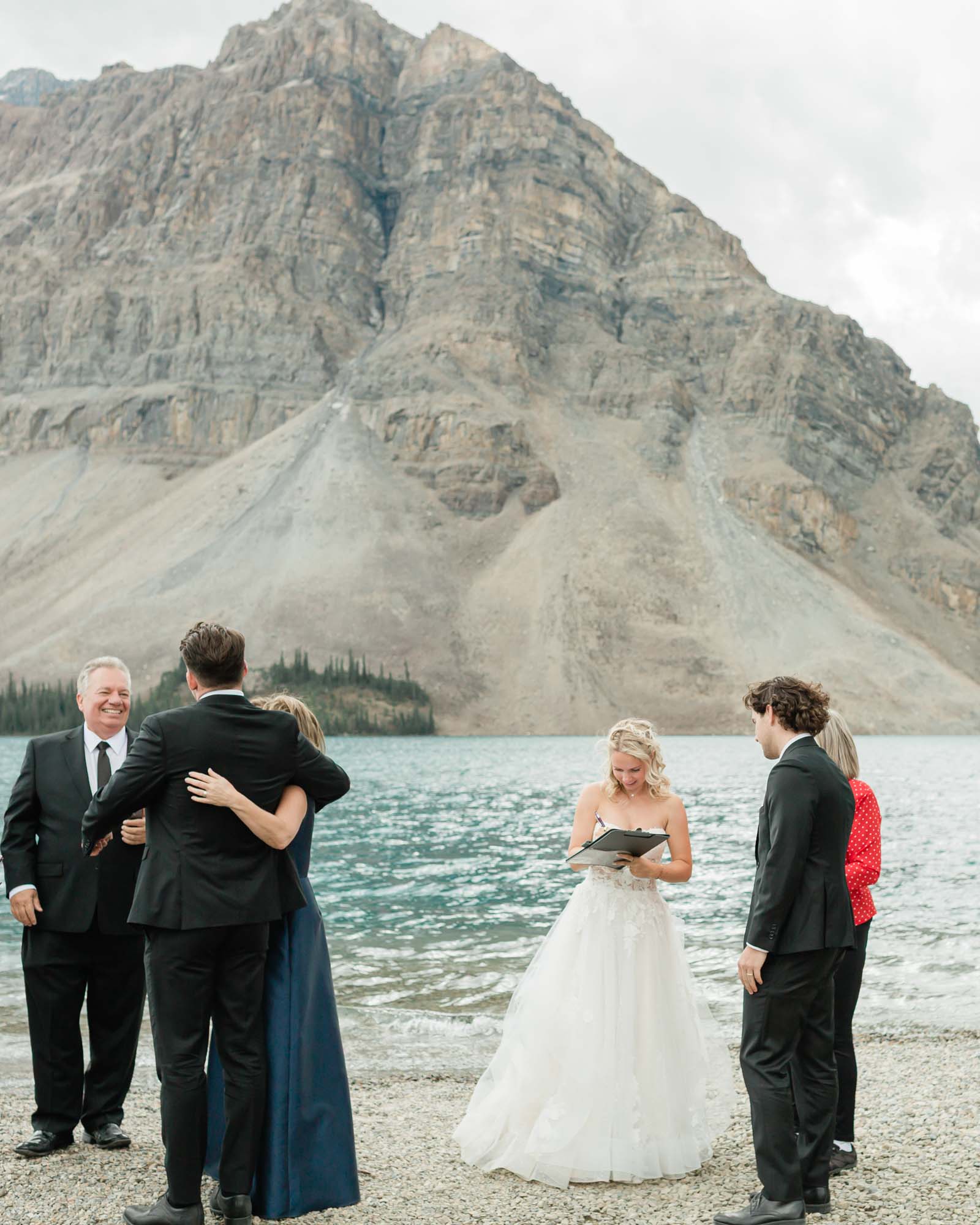 tyler, sarah and guests celebrating together after their ceremony at bow lake for their summer banff elopement 