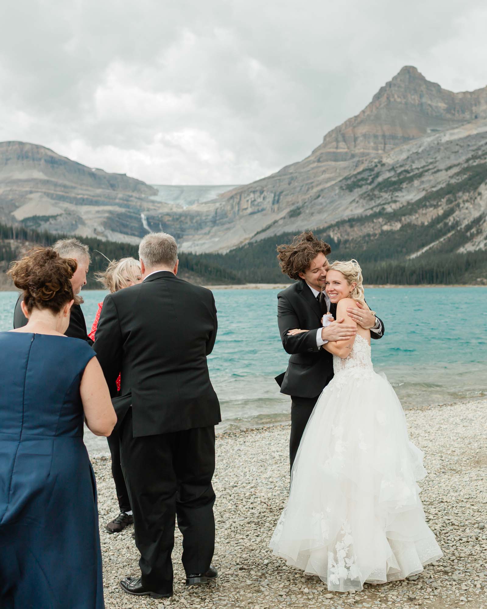 tyler, sarah and guests celebrating together after their ceremony at bow lake for their summer banff elopement 