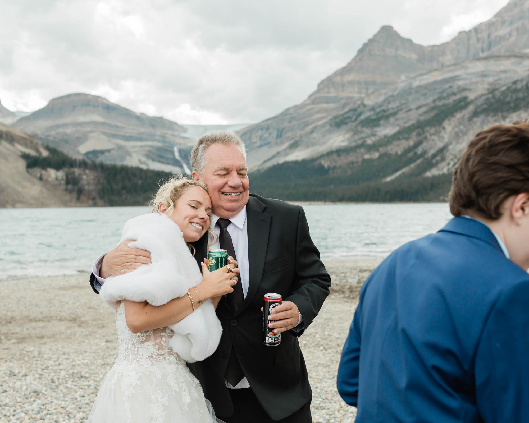sarah and her dad hugging after her banff wedding 