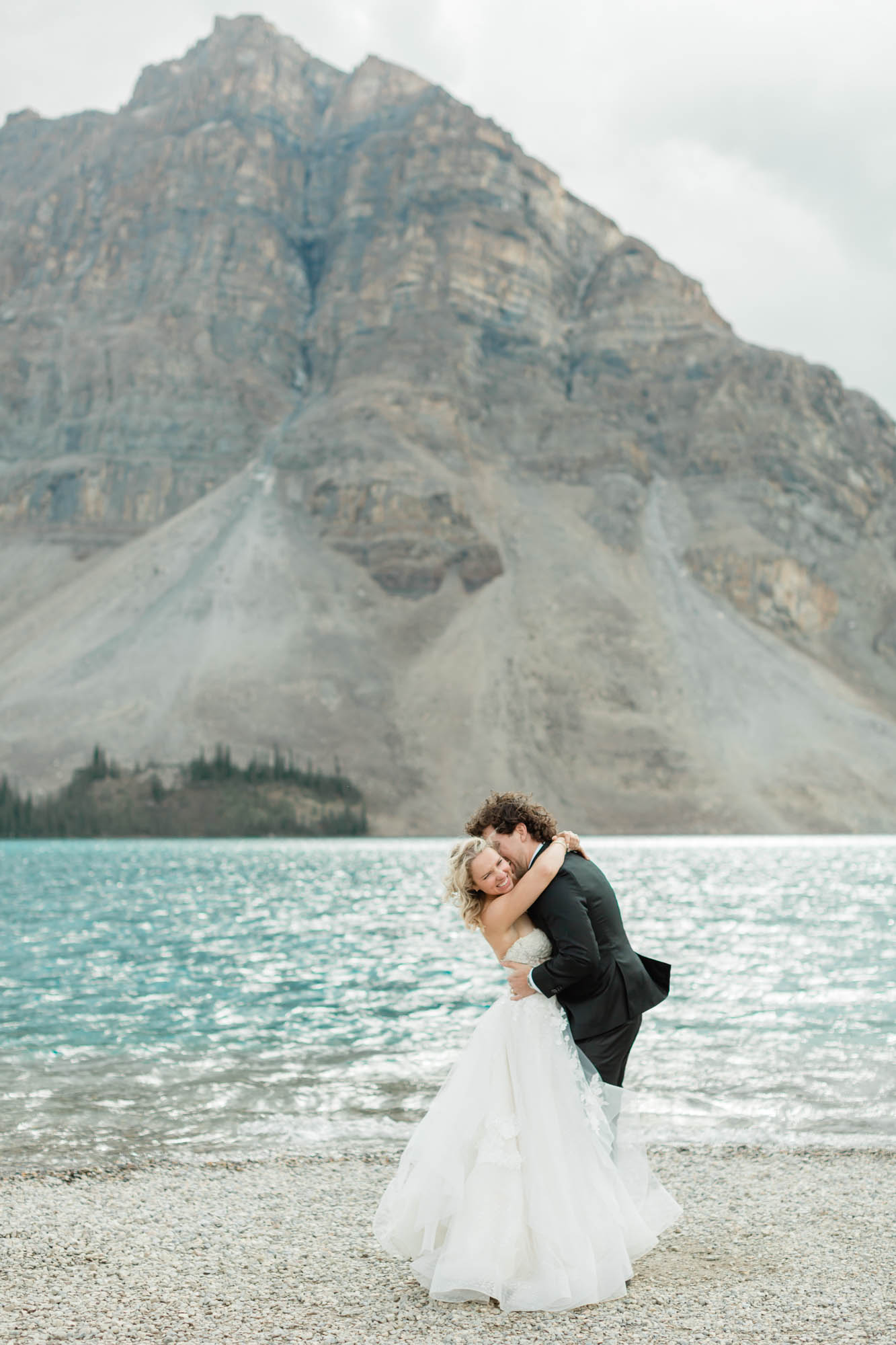 sarah and tyler hugging in front of a mountain backdrop