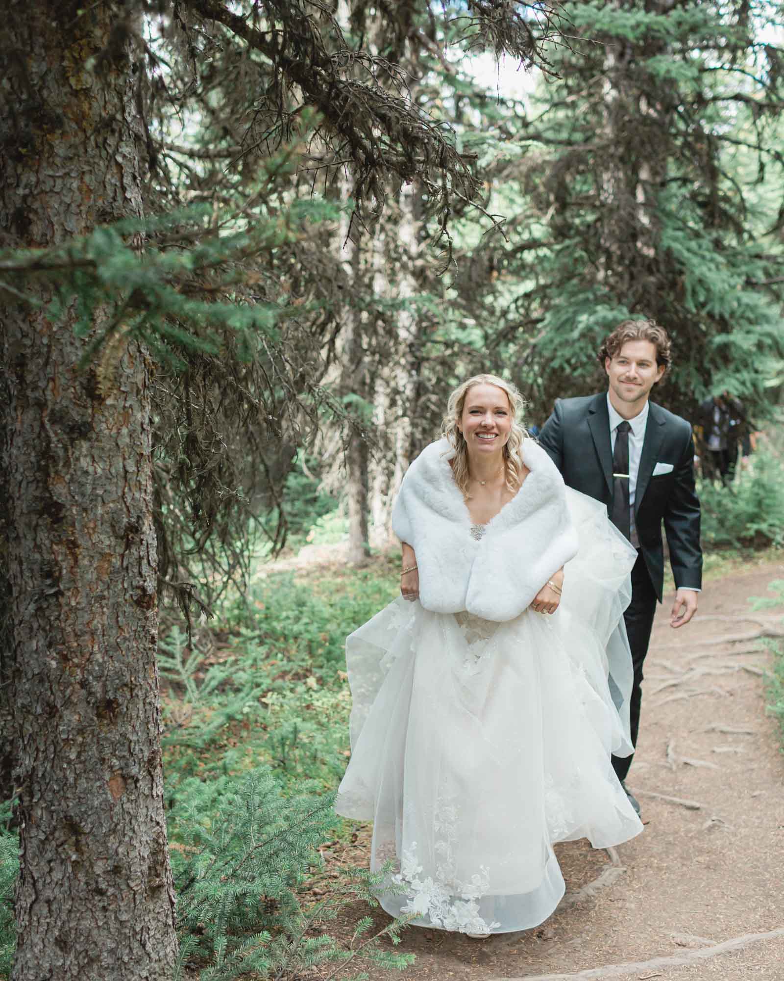 sarah and tyler walking through the forest on their way to peyto lake 