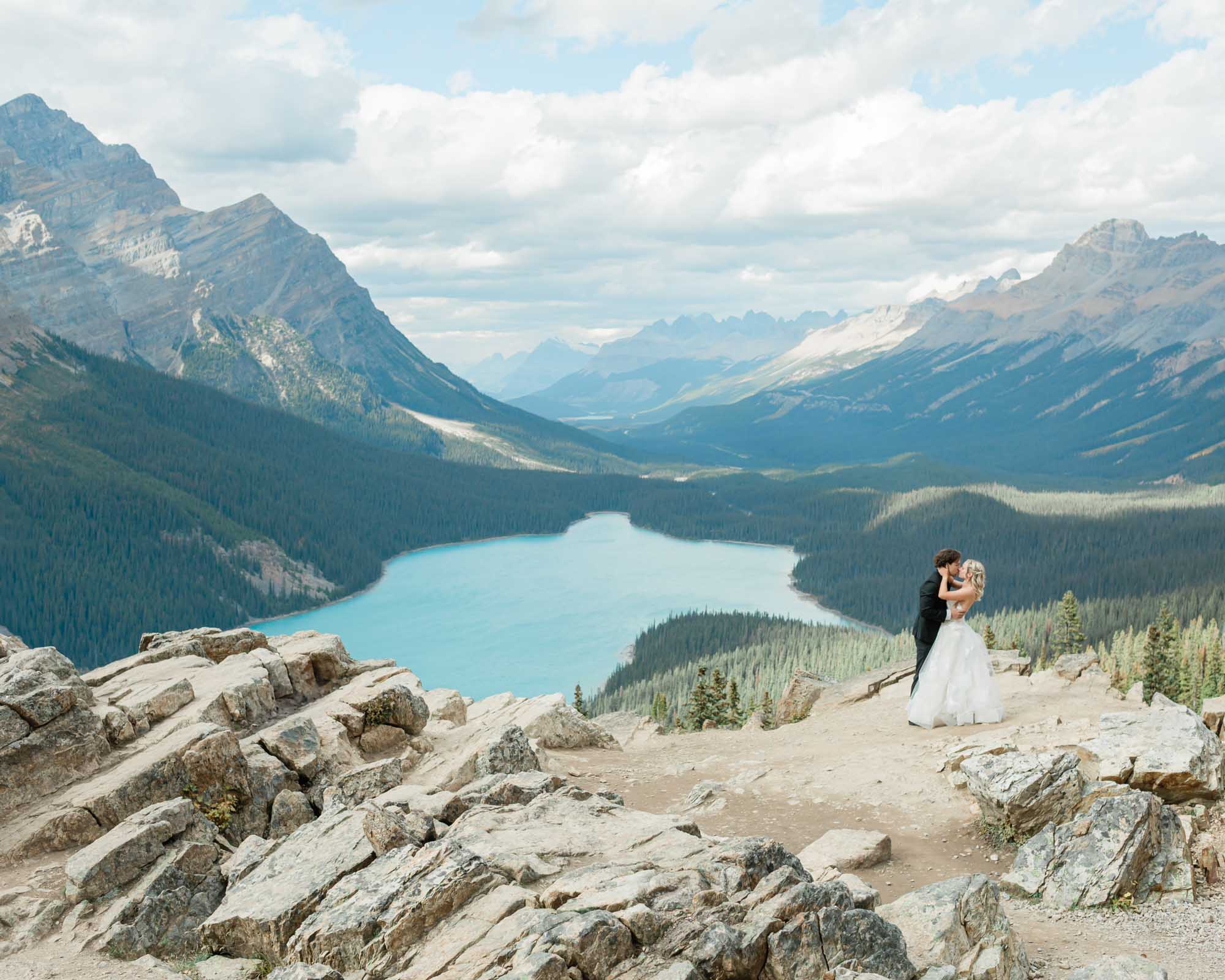 sarah and tyler embracing in front of peyto lake after their banff wedding