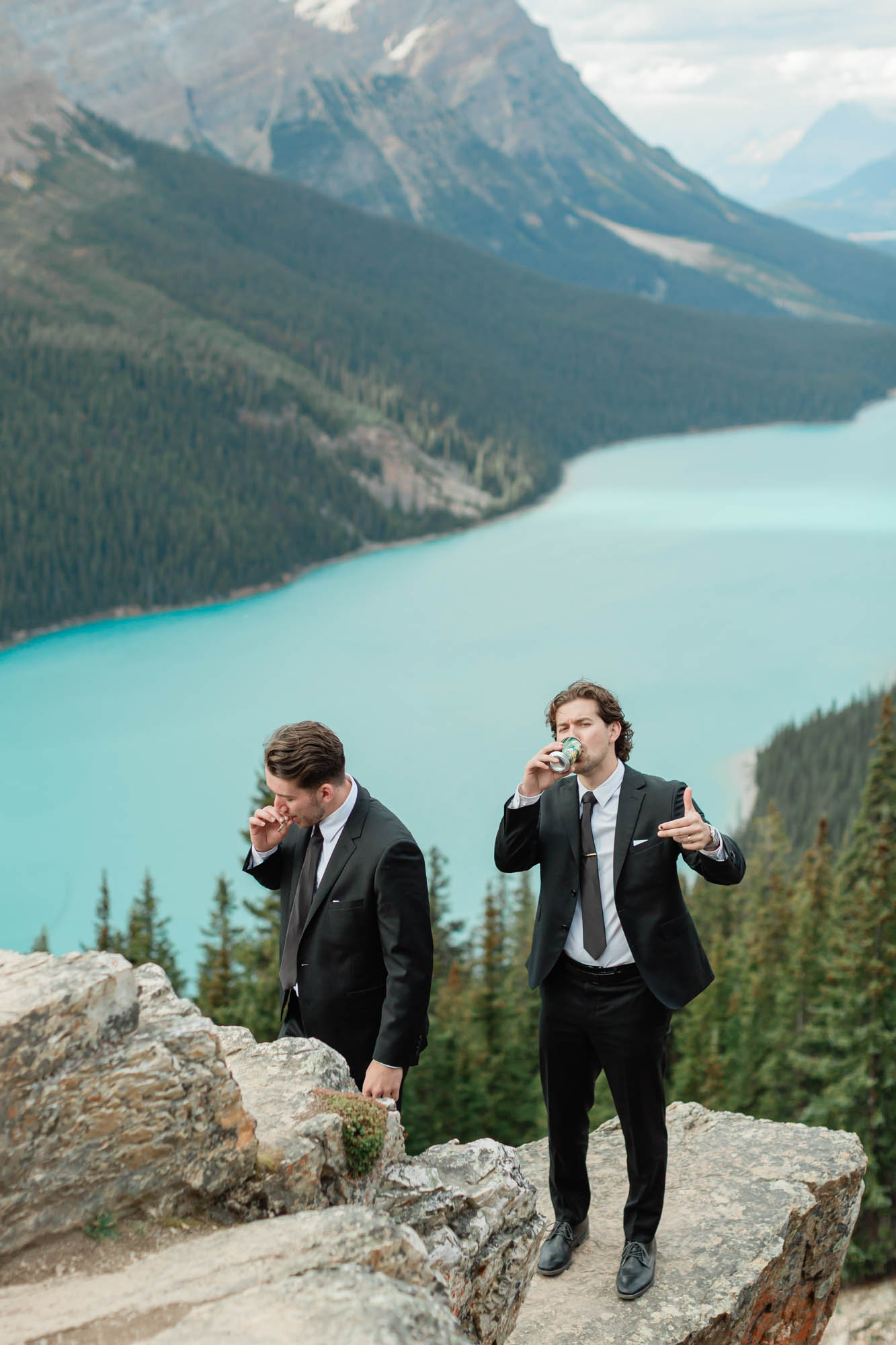 tyler and his brother sharing a beer and a joint while looking out at the epic banff mountain views for his elopement 