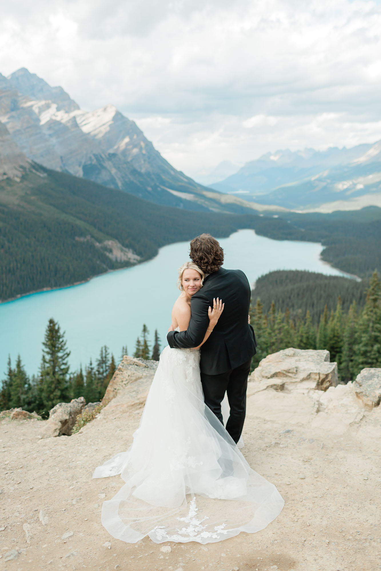 Sarah looking back at her family at Peyto lake for their wedding portraits