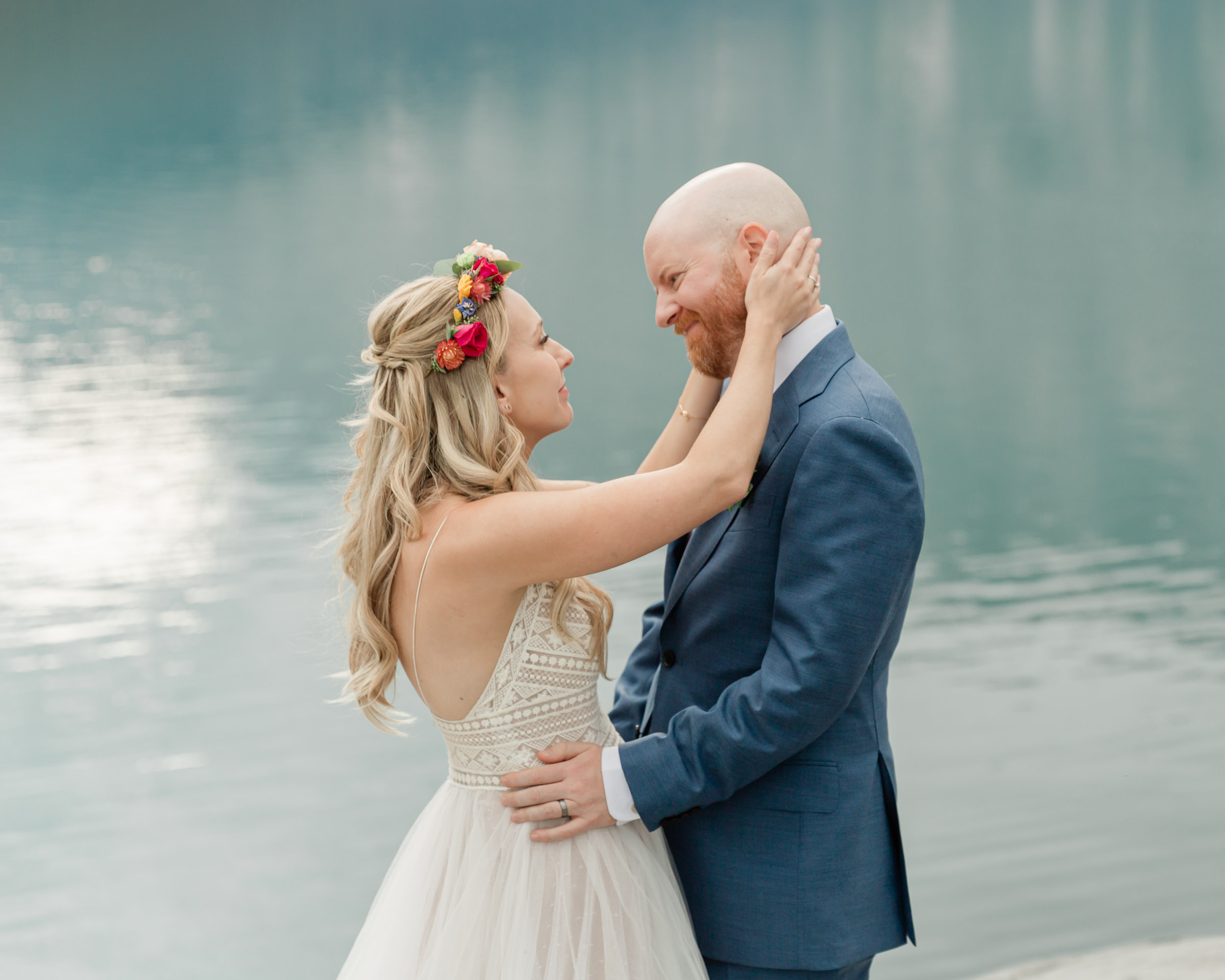 the couple posing for the camera during their mountain wedding near banff