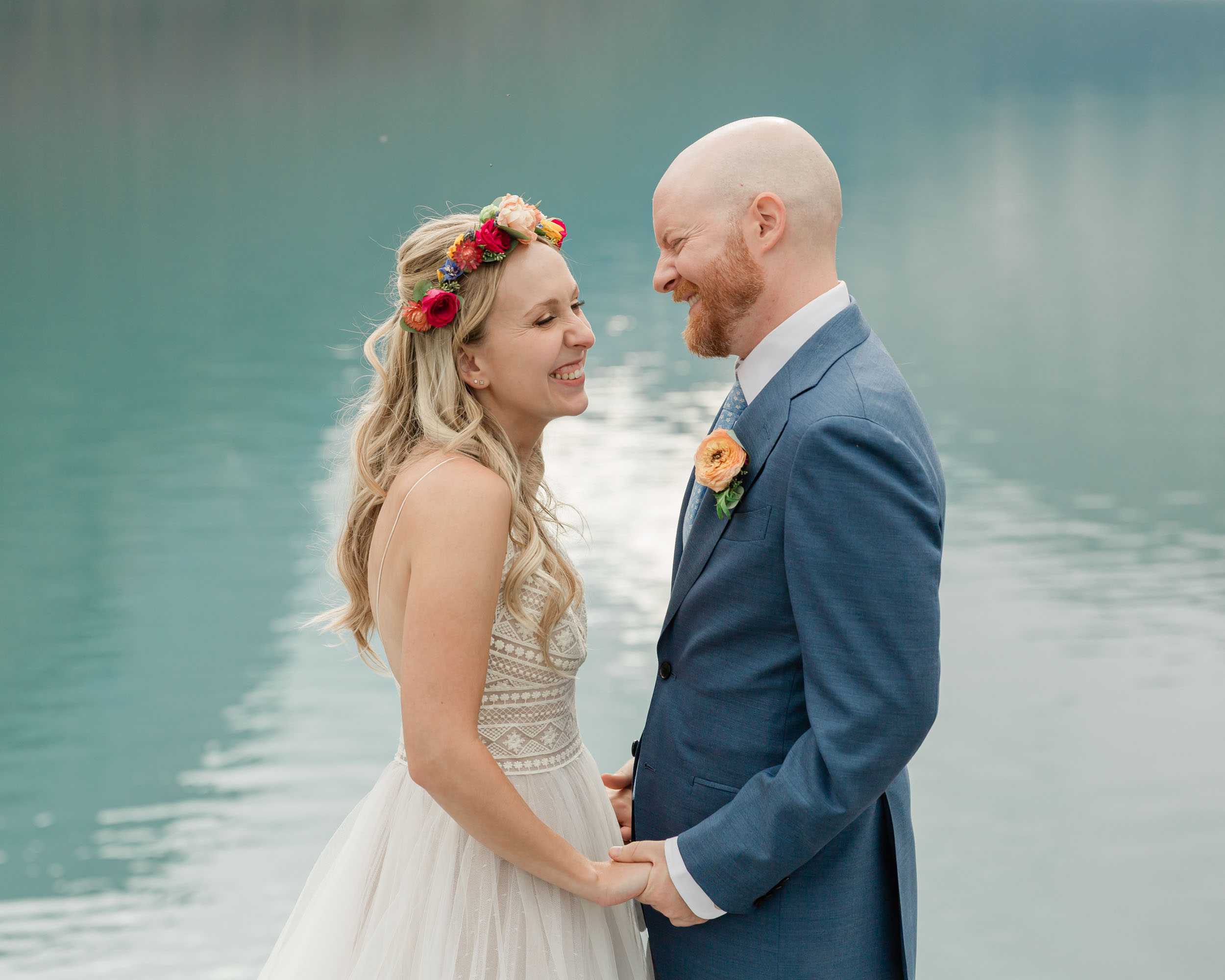 the couple posing for the camera during their mountain wedding near banff