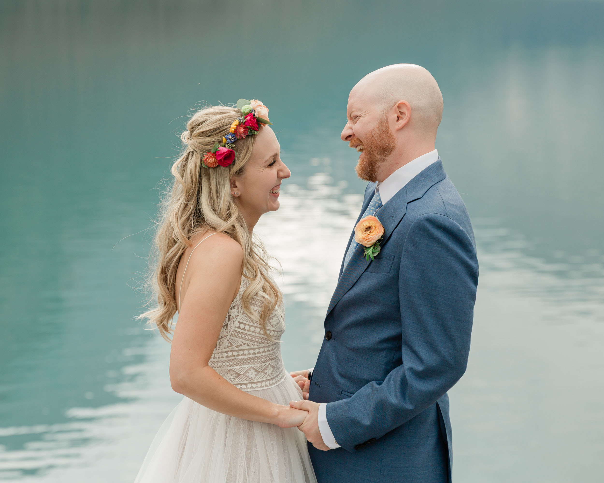 the couple posing for the camera during their mountain wedding near banff