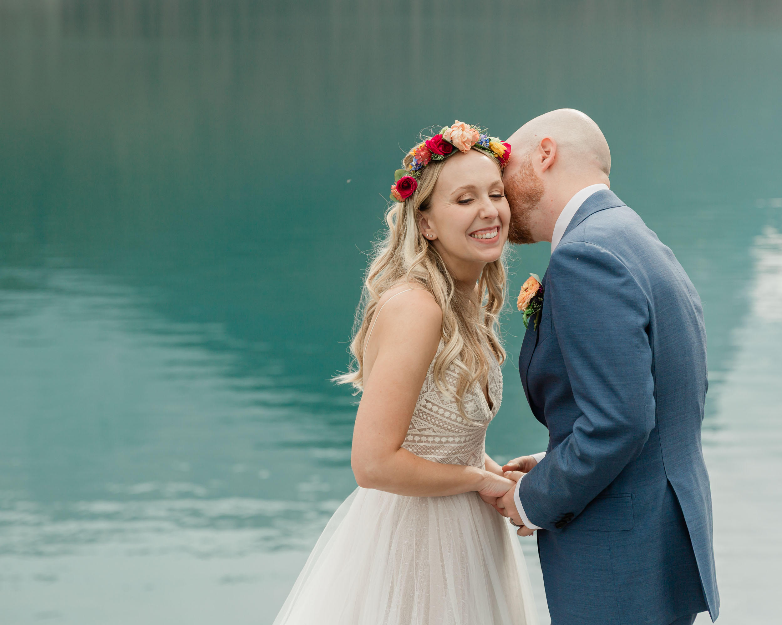 the couple posing for the camera during their mountain wedding near banff