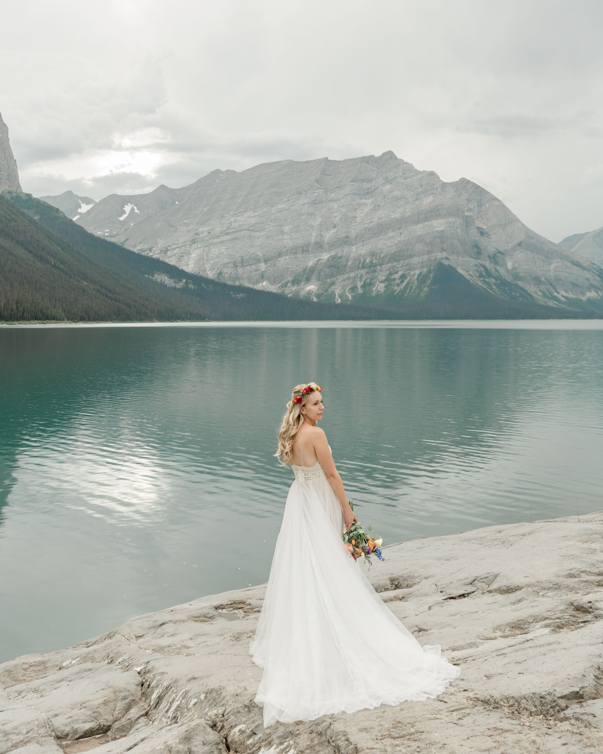 the bride posing for the camera during their mountain wedding near banff