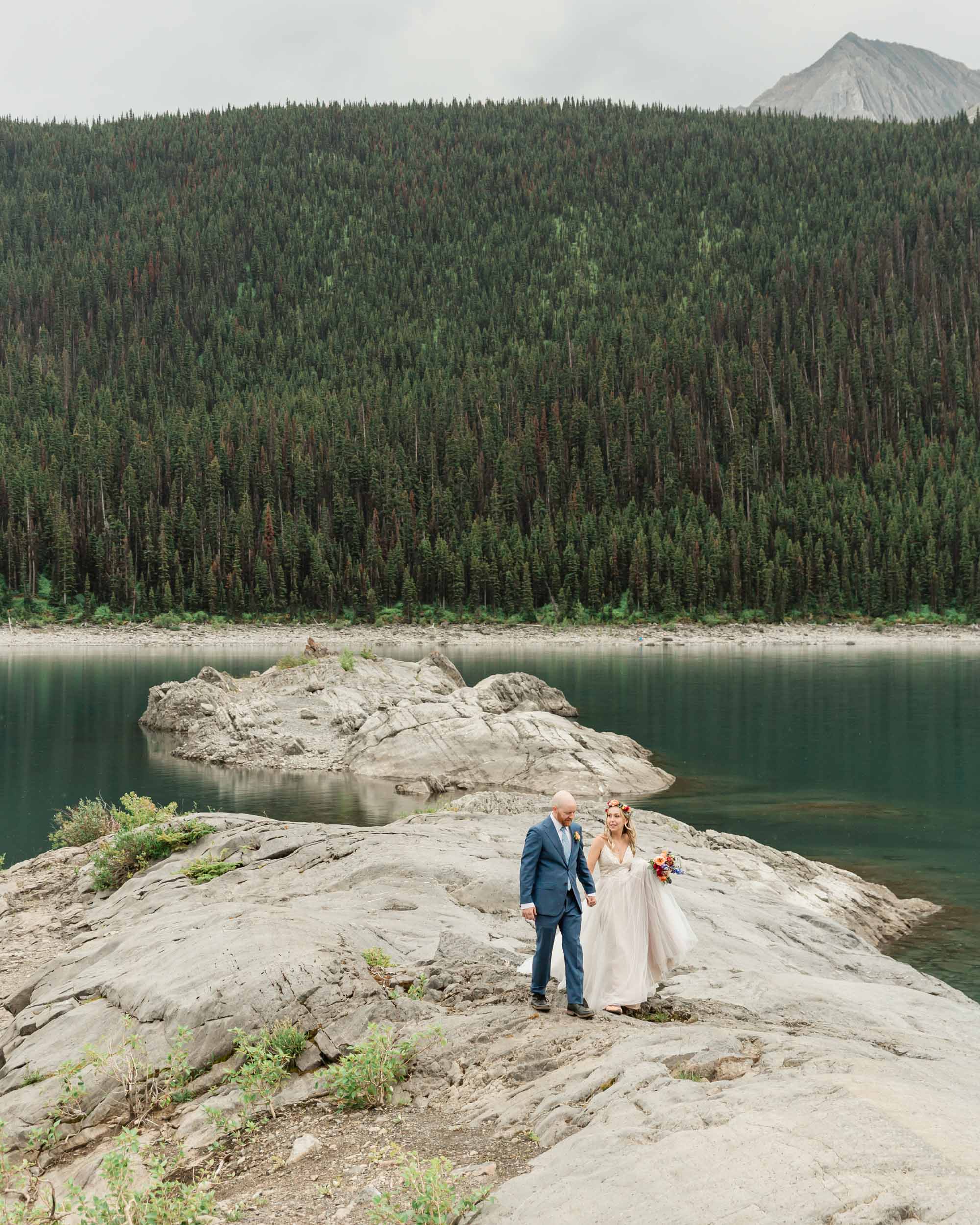 the couple posing for the camera during their mountain wedding near banff