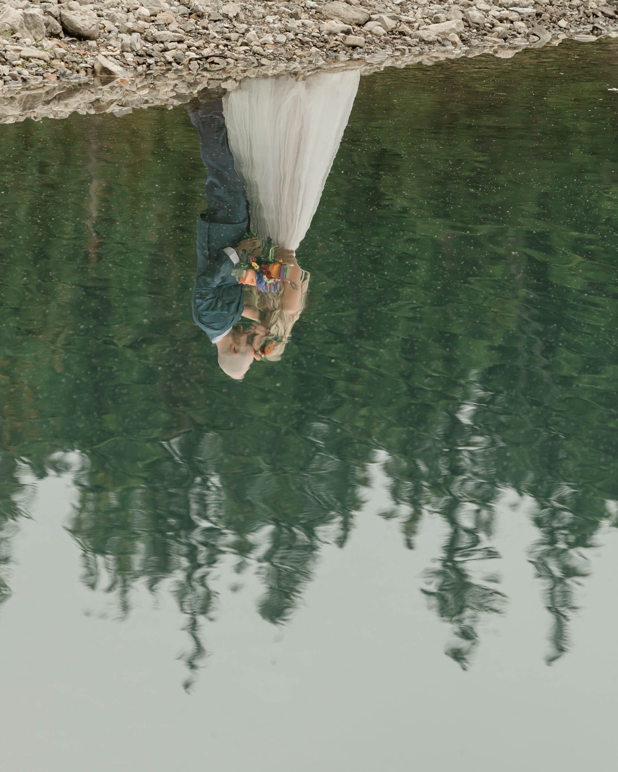 the couple posing for the camera during their mountain wedding near banff
