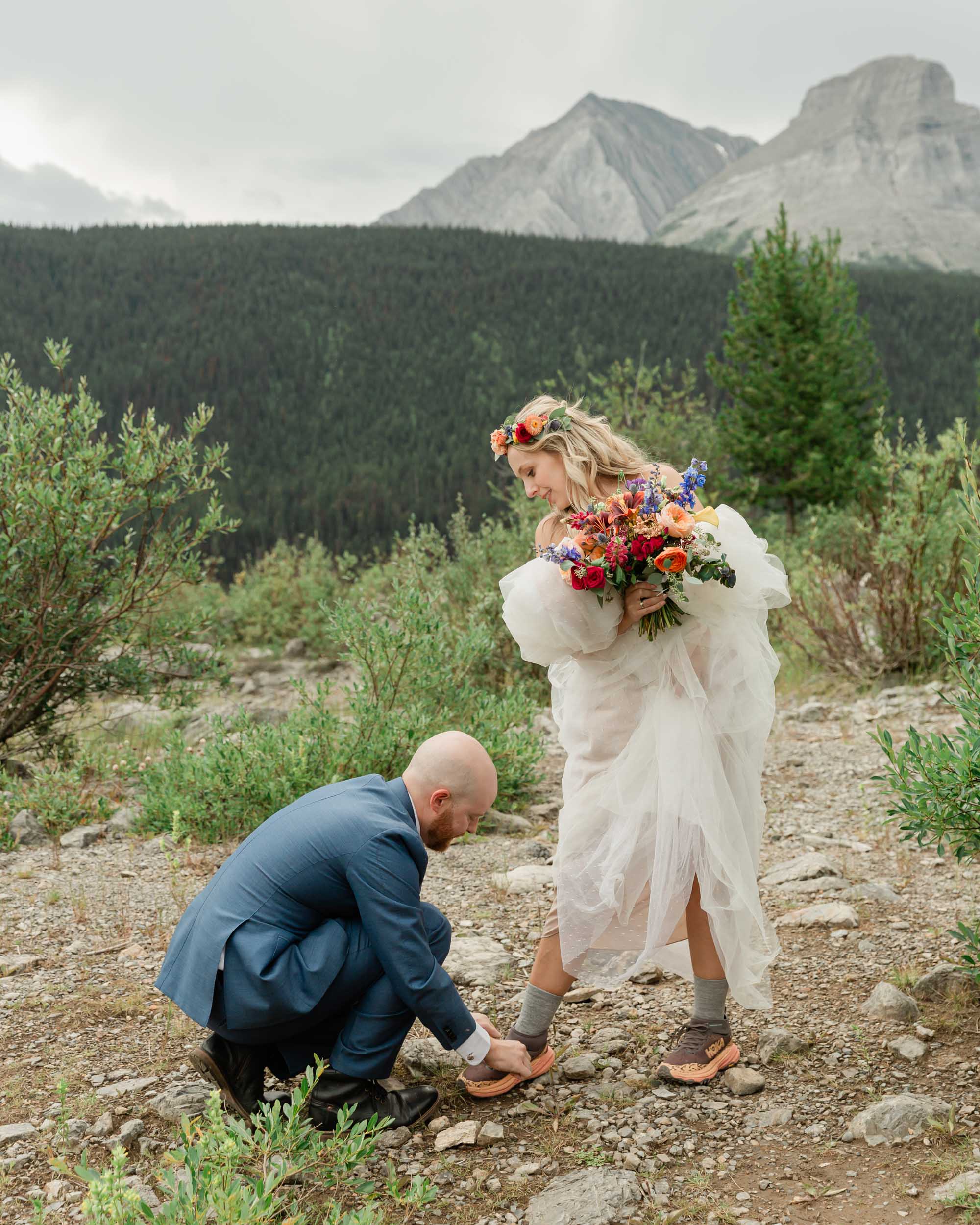 the couple posing for the camera during their mountain wedding near banff