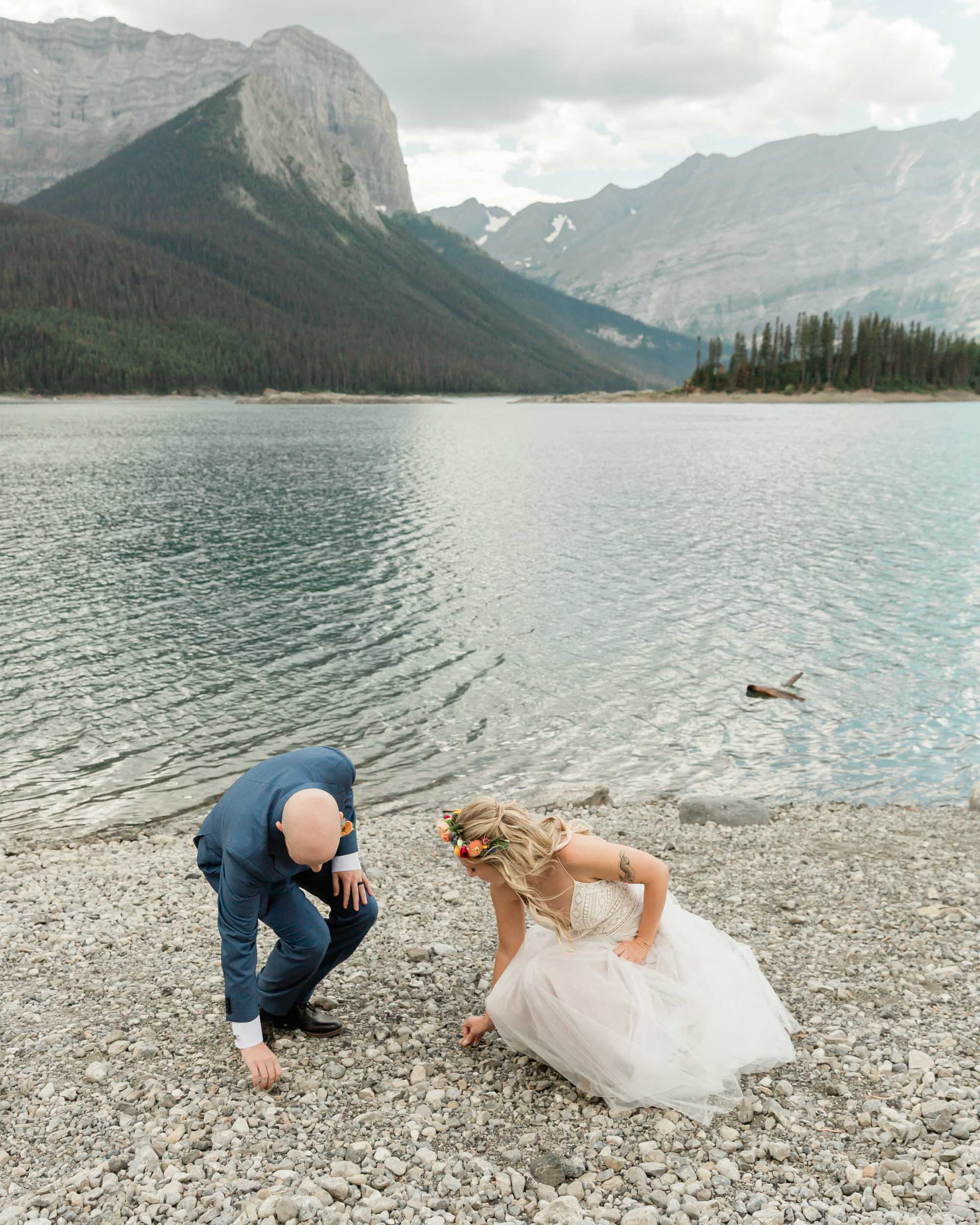 the couple skipping rocks during their kananaskis mountain elopement 
