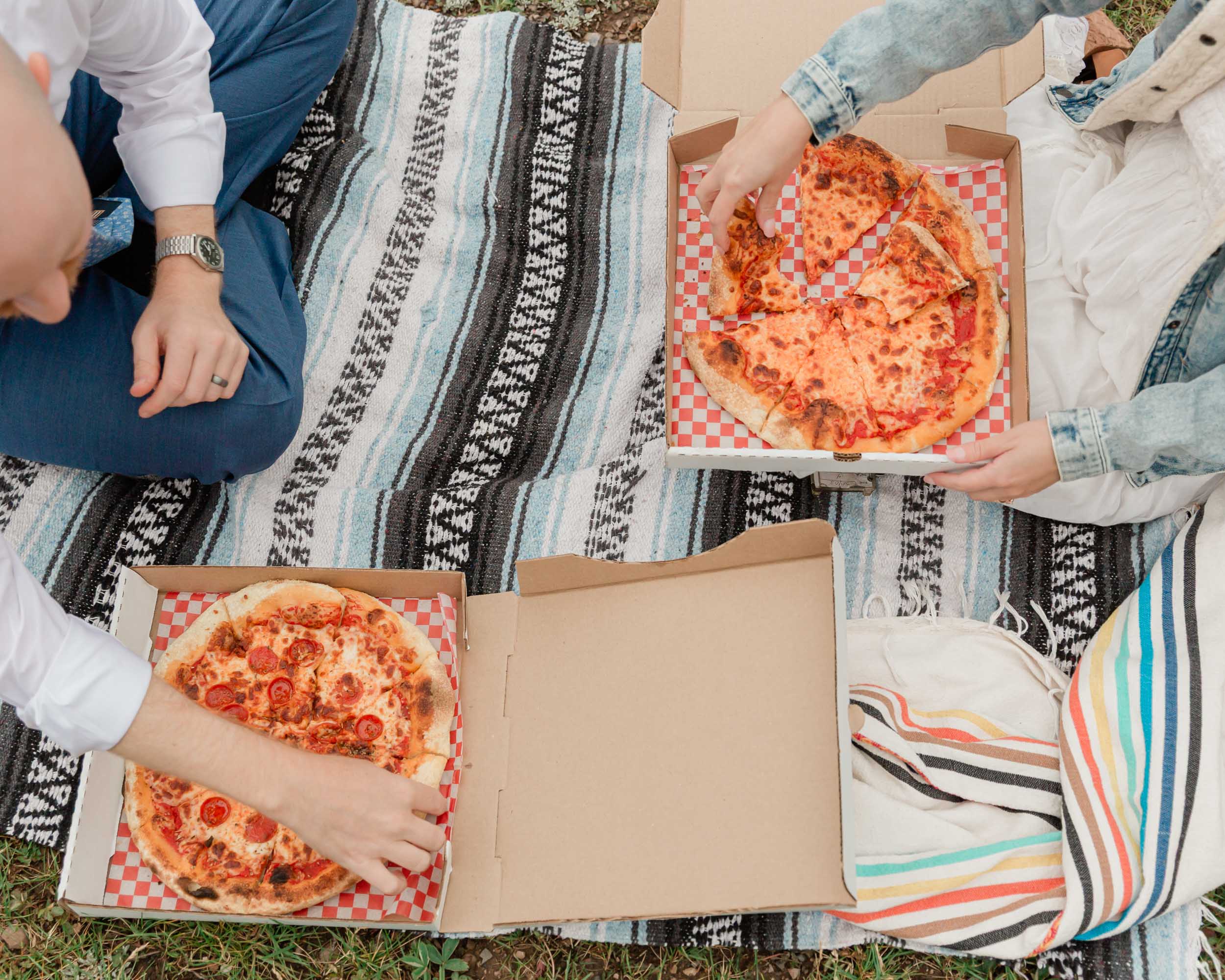 eating pizza celebrating after their ceremony during their mountain wedding near banff