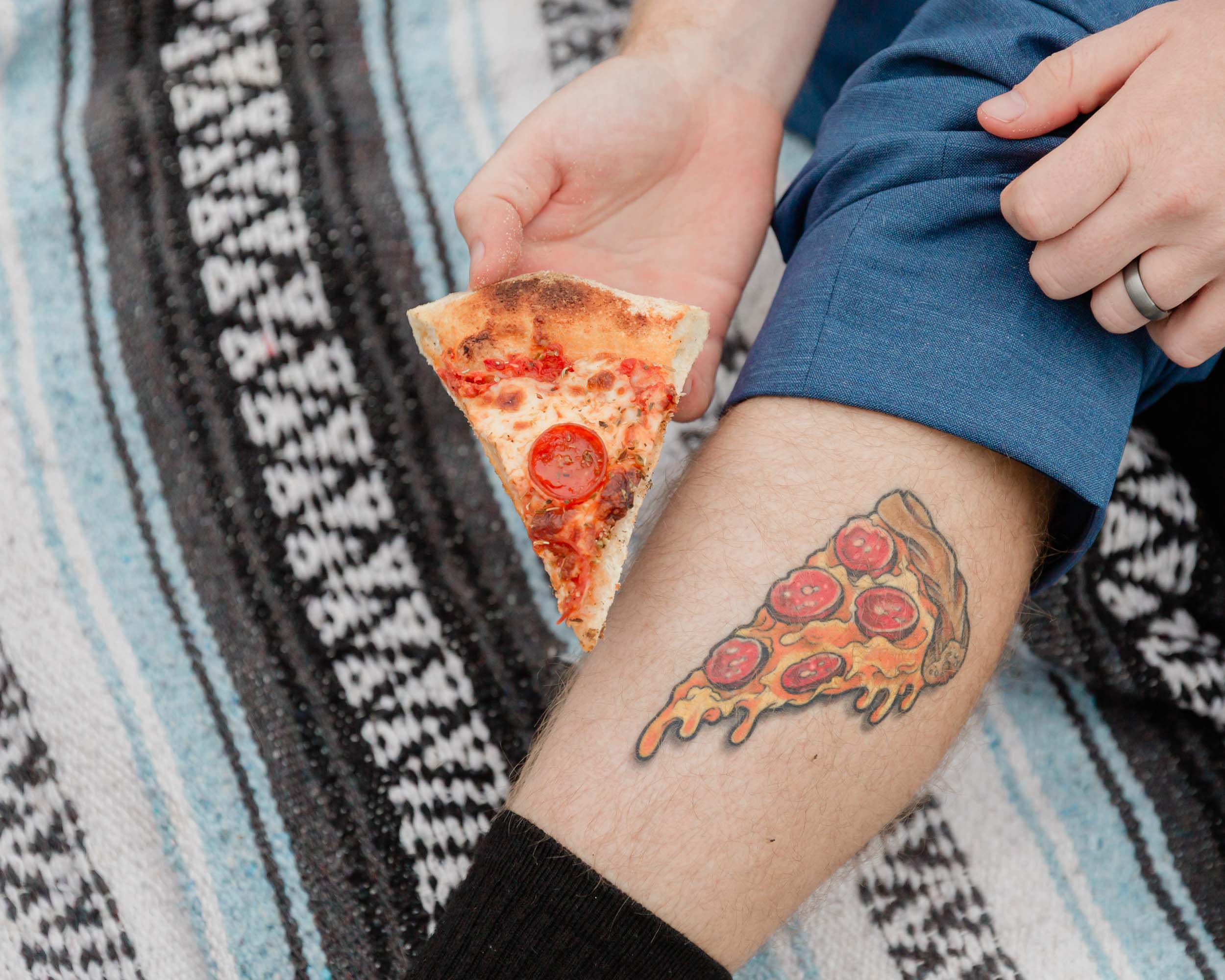 pizza slice and pizza tattoo close up for the groom