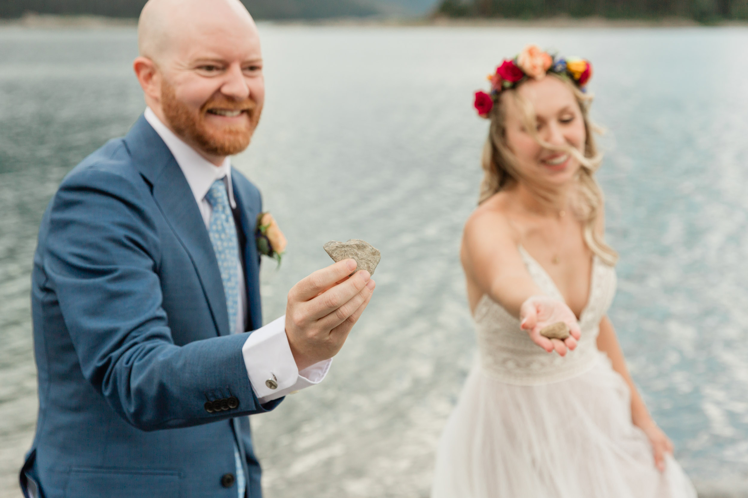 the couple showing us a rock before skipping it on the blue alpine lake