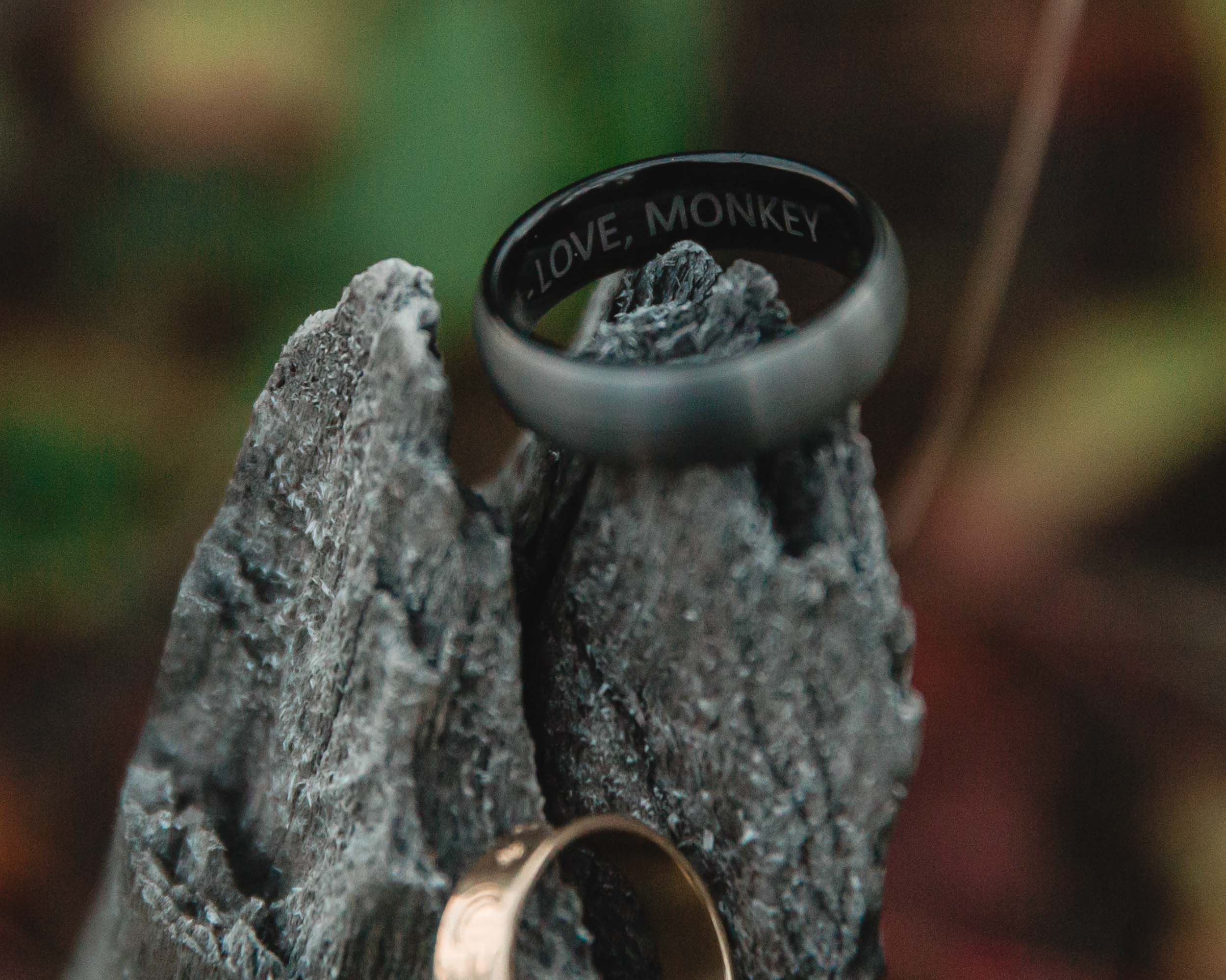 close up of the wedding rings inscribed love monkey