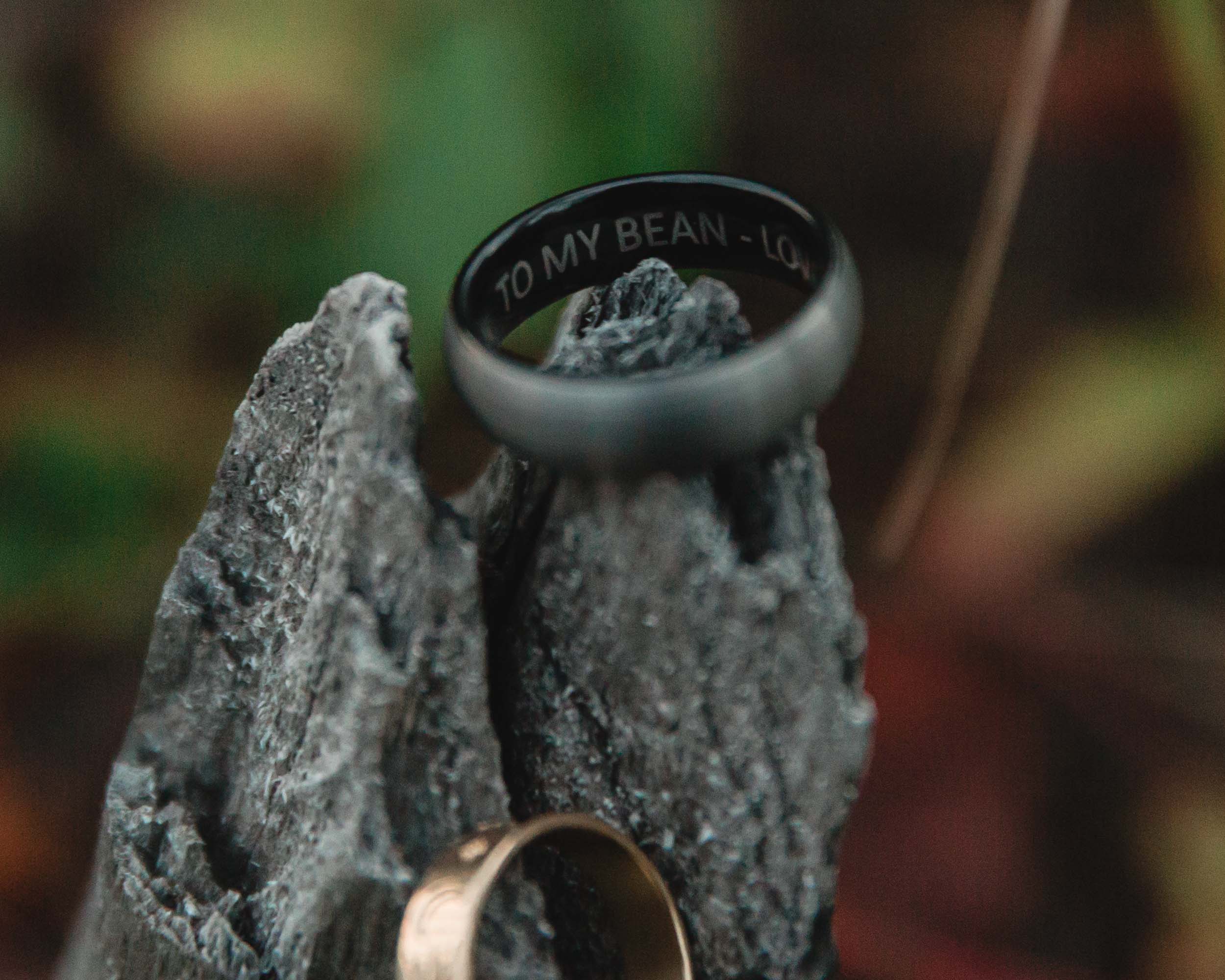 close up of the wedding rings inscribed to my bean