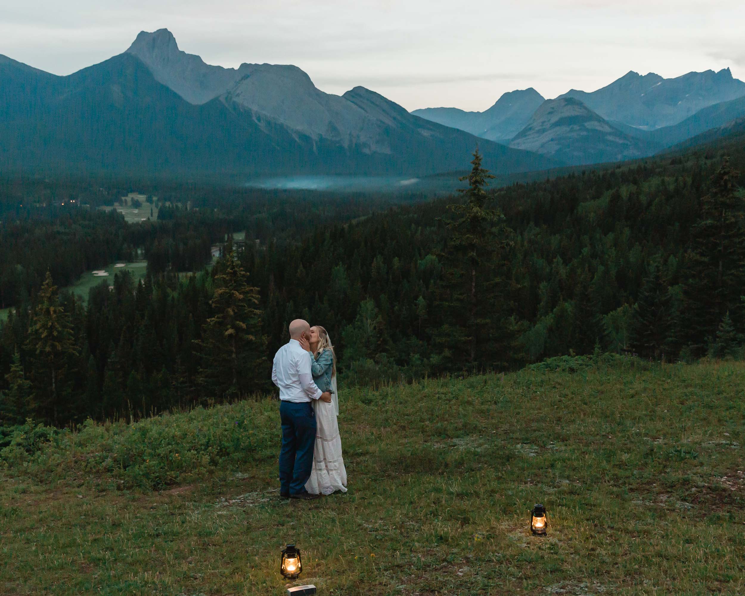 megan and scott embracing during their first dance with the banff mountain range behind them for their elopement day