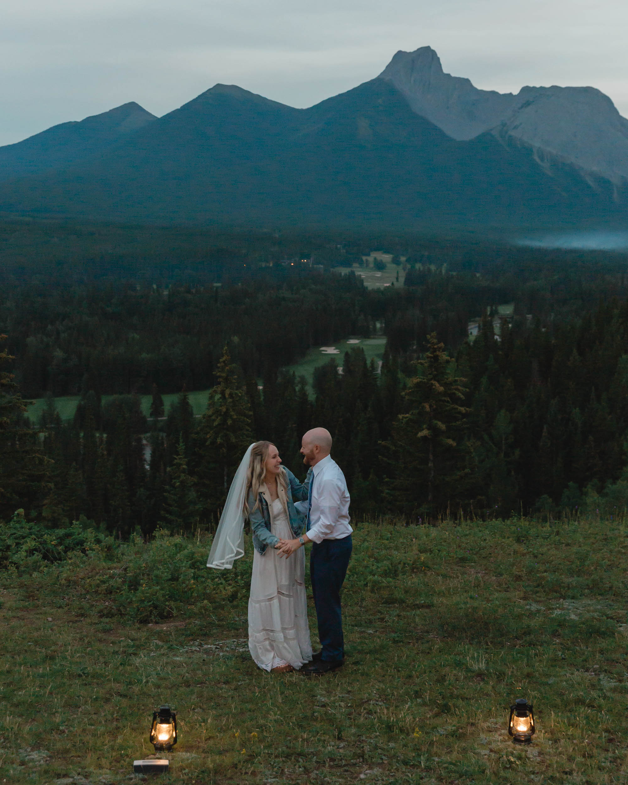 megan and scott embracing during their first dance with the banff mountain range behind them for their elopement day