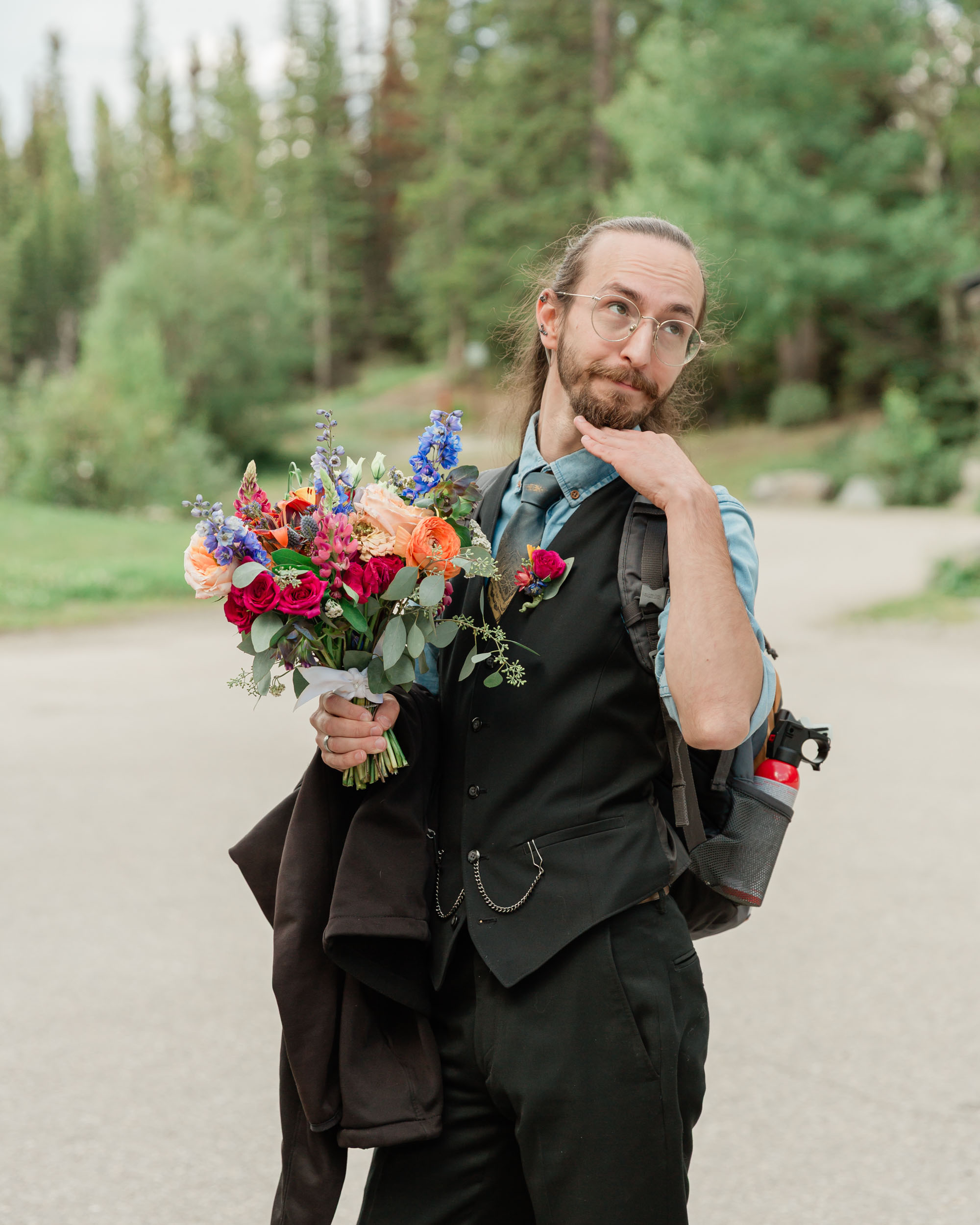 carter posing looking right holding his sisters bouquet