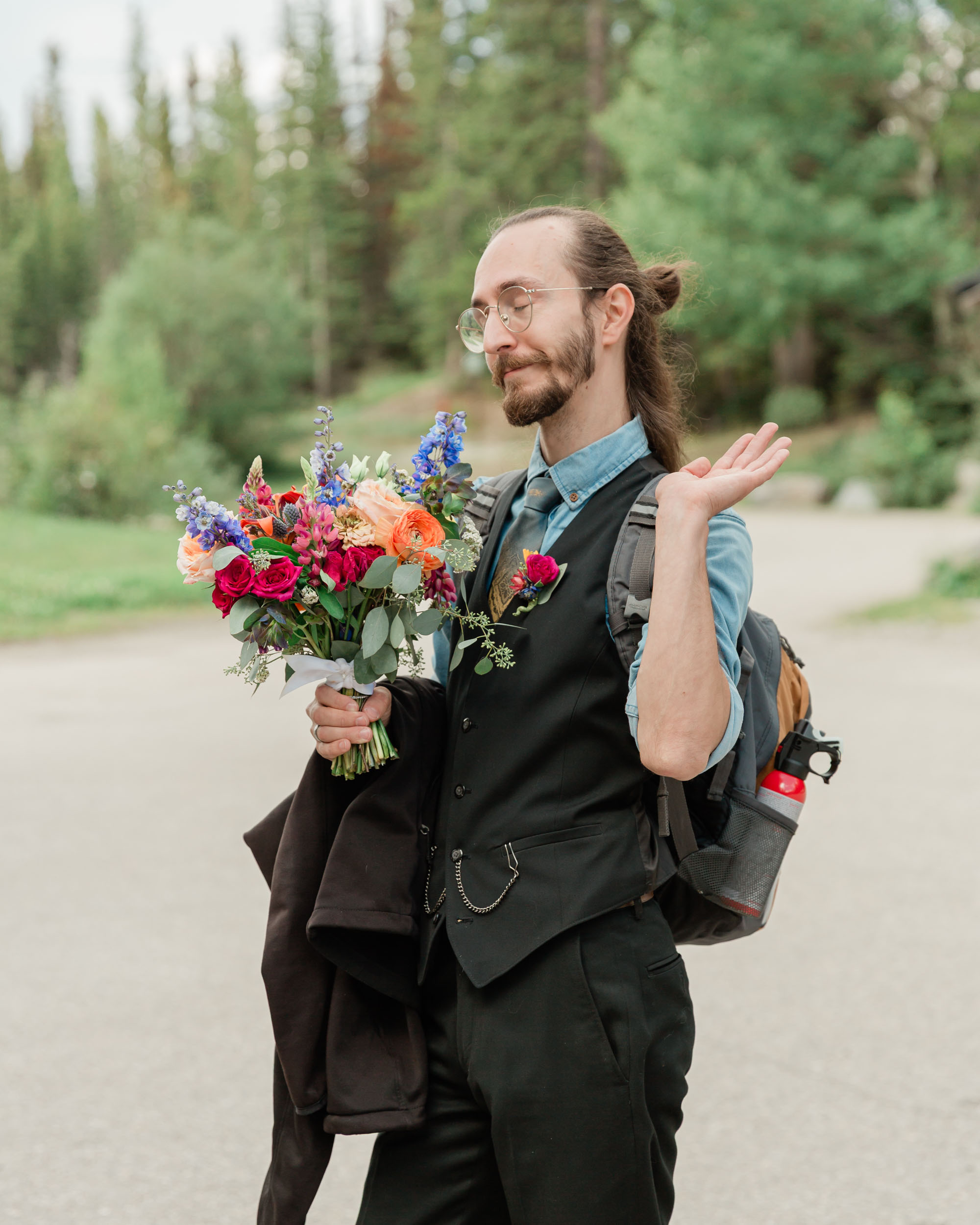 carter posing looking left holding his sisters bouquet