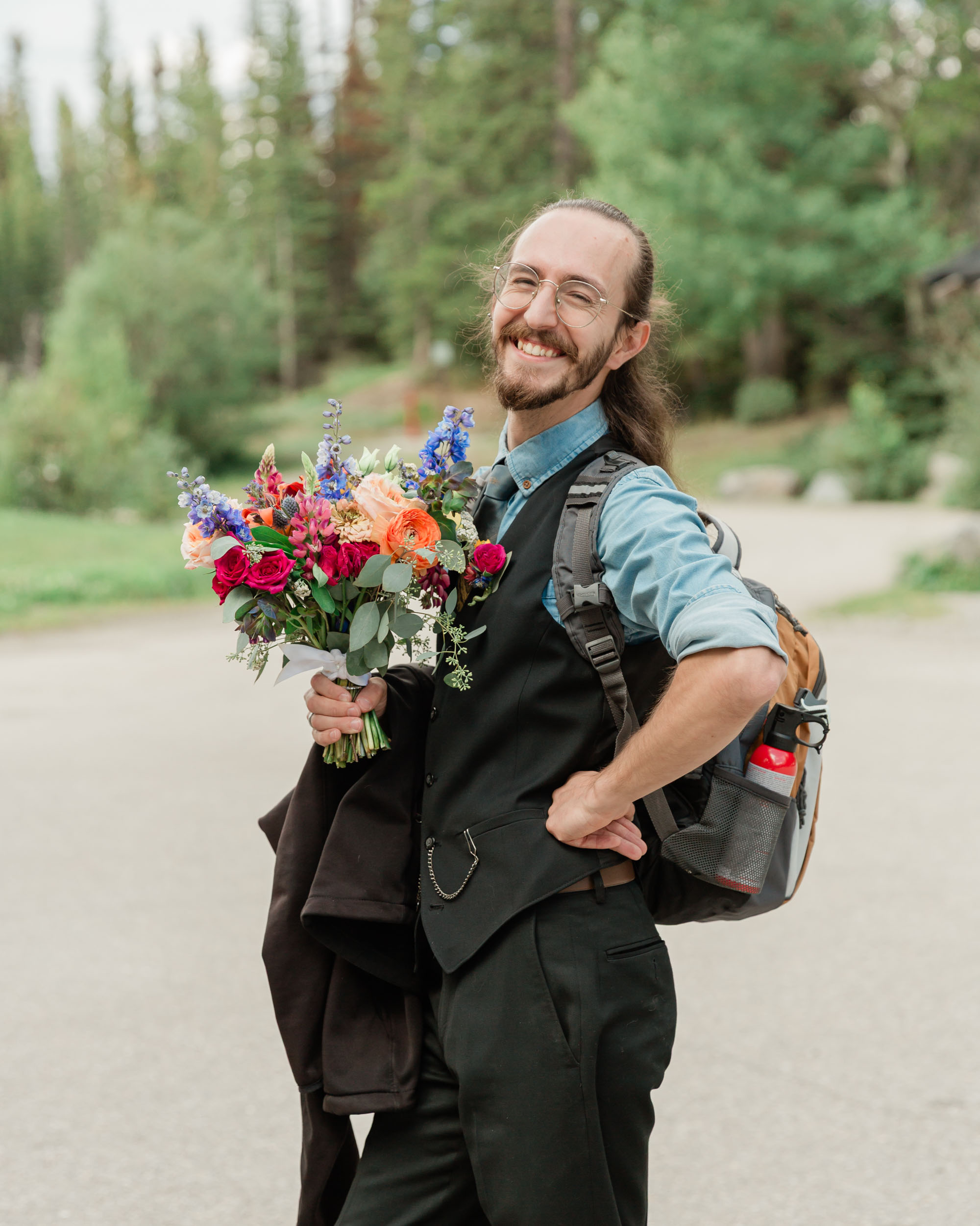 carter posing looking at the camera and smiling holding his sisters bouquet