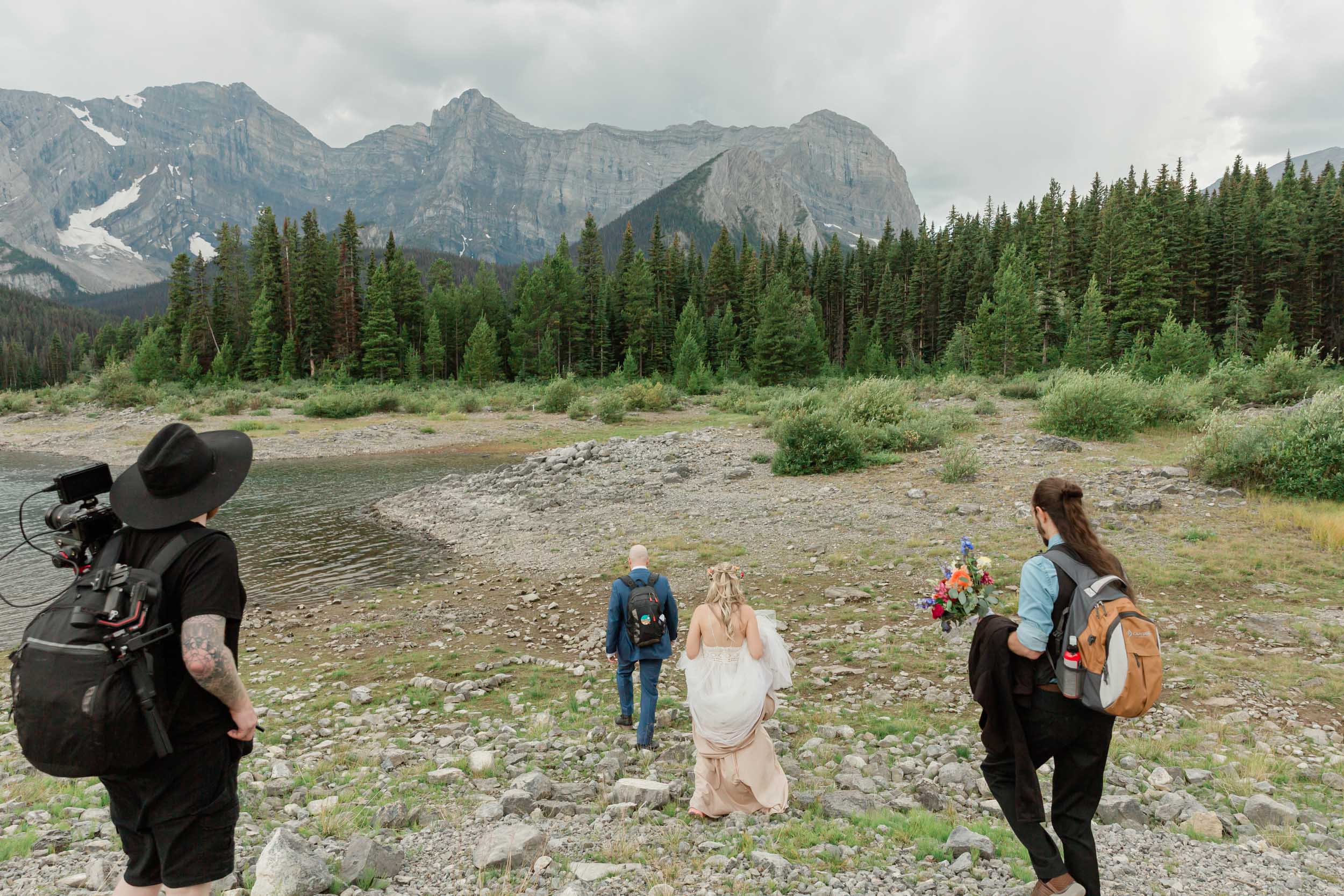 we are all hiking during scott and megan's elopement with the banff mountains in the background