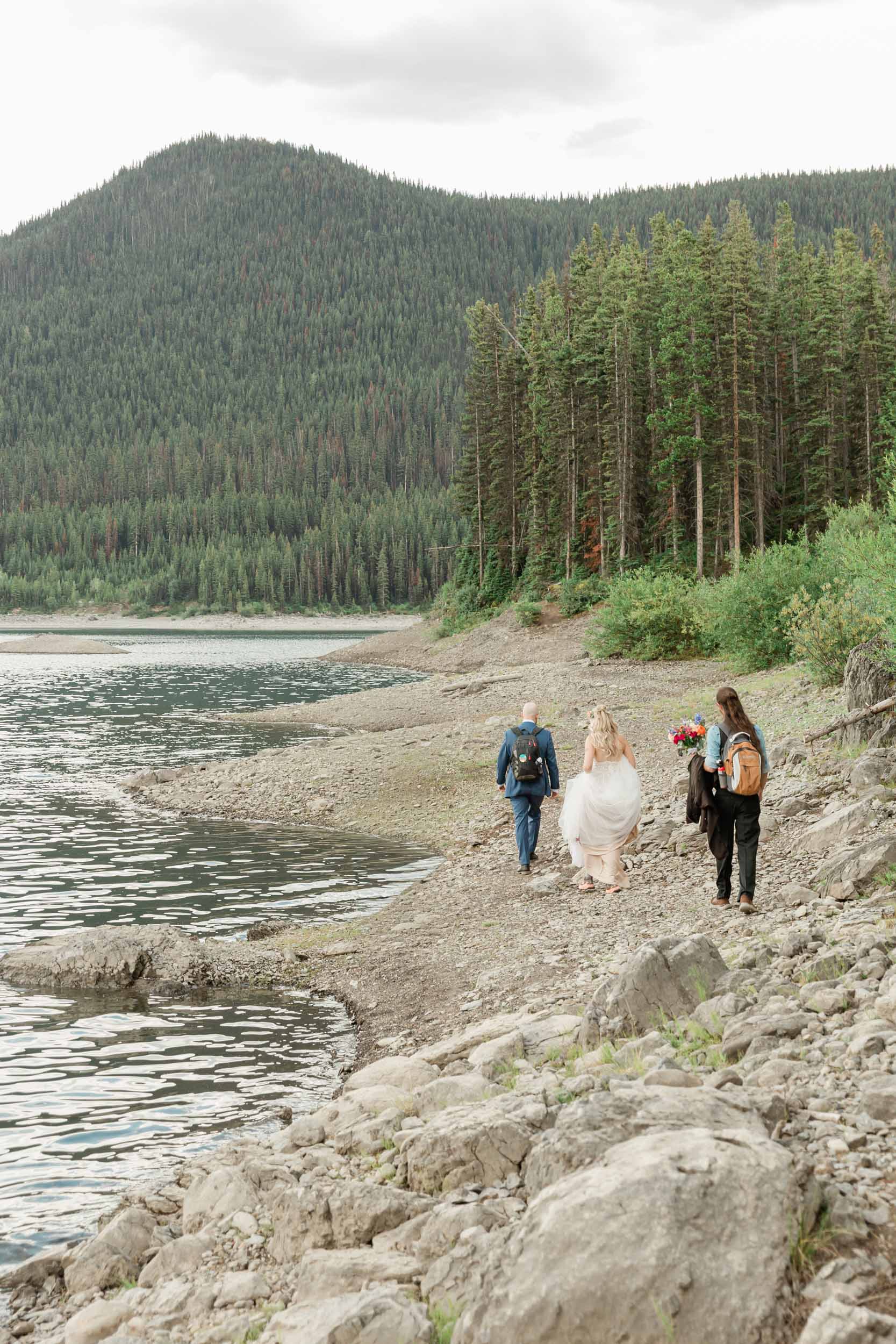 walking towards their ceremony for the couple's kananaskis mountain elopement 