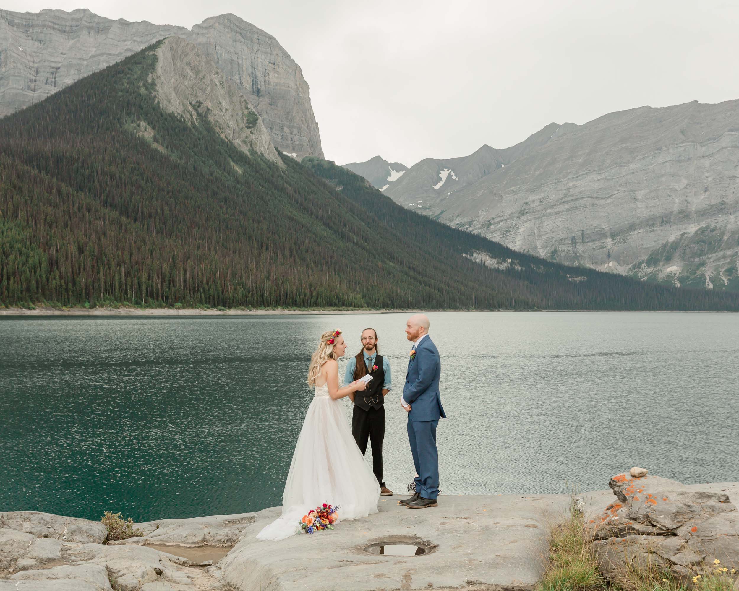 megan and scott exchanging vows during their ceremony for their kananaskis mountain elopement 