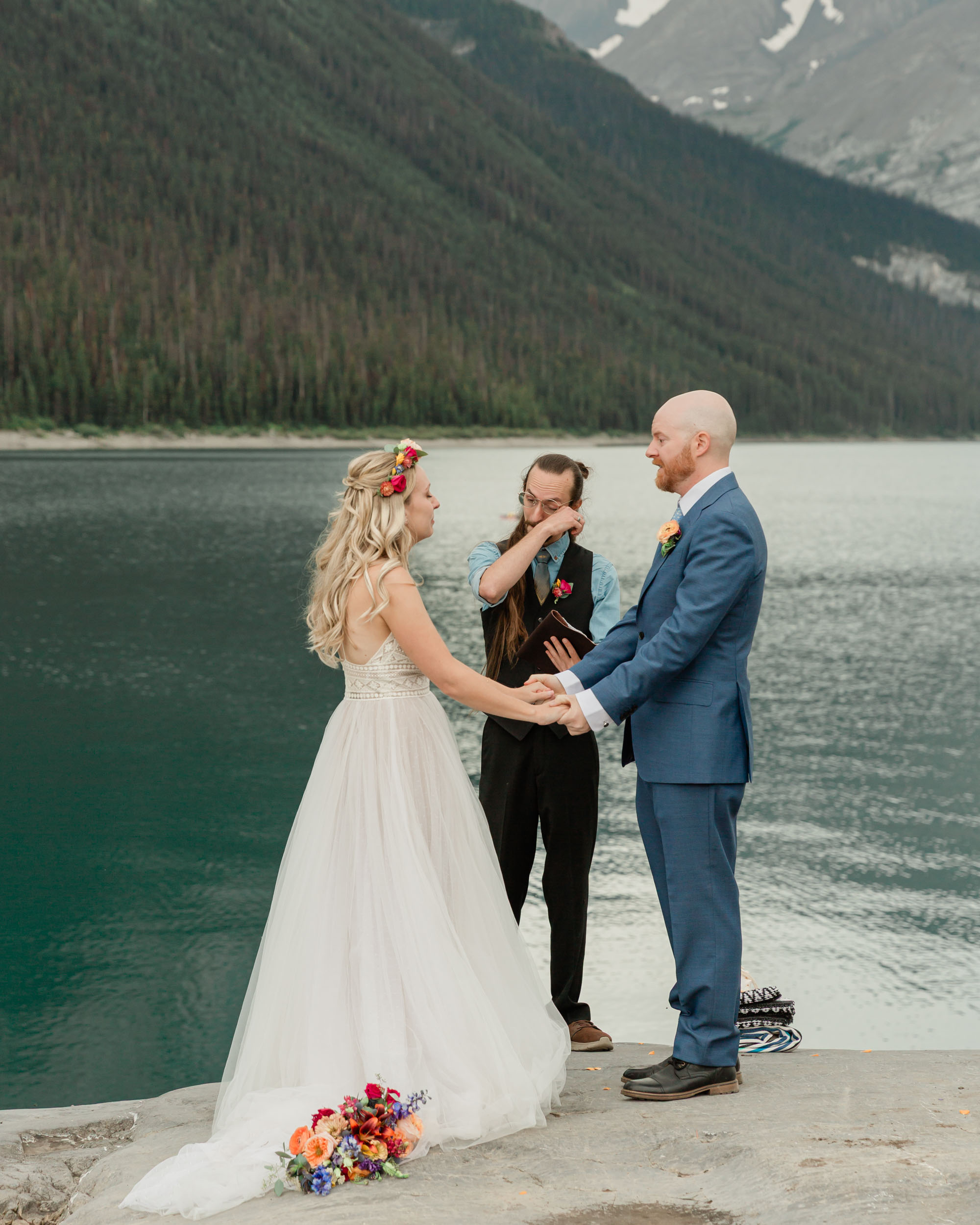 the couple reciting their vows and exchanging rings for their kananaskis mountain elopement ceremony