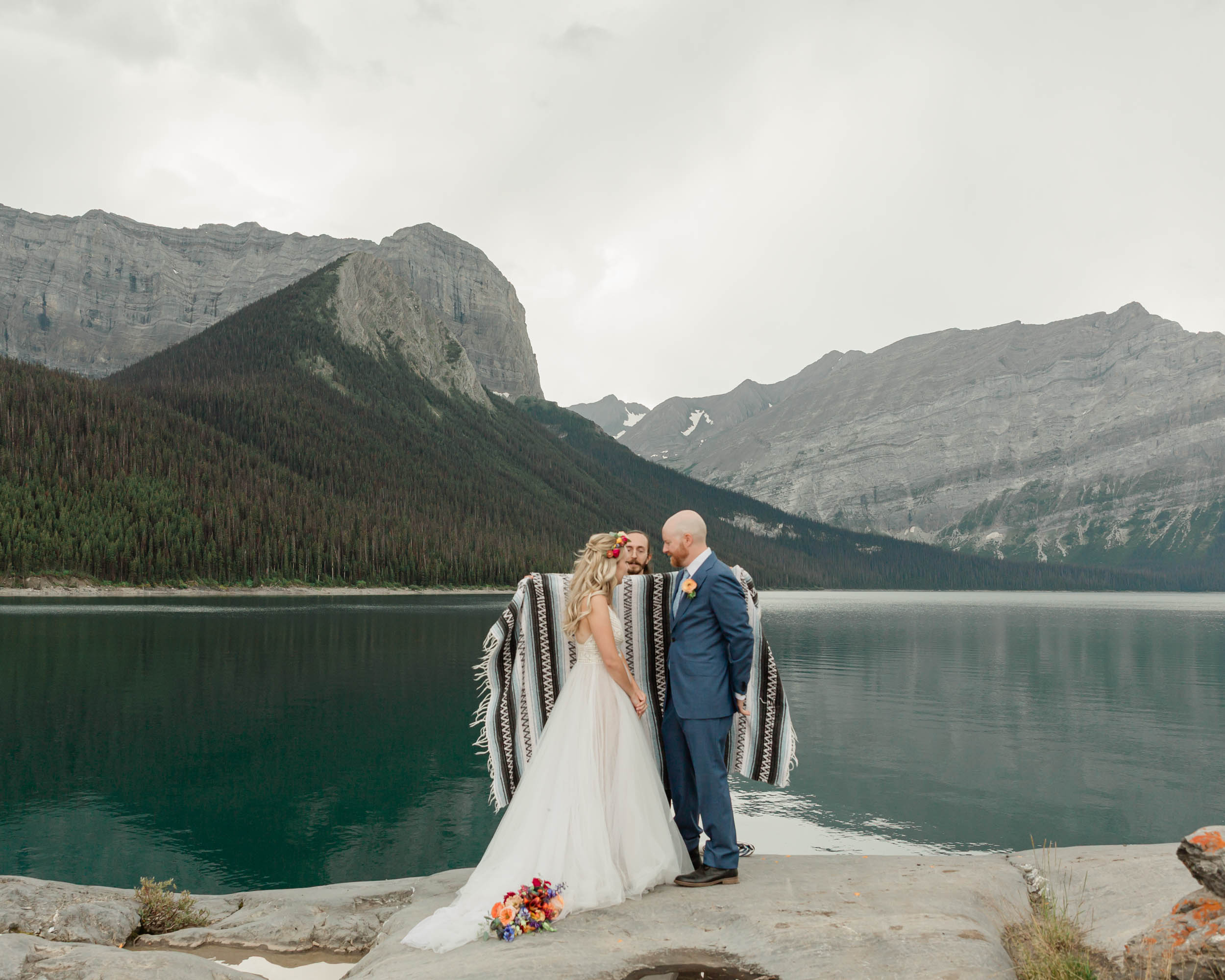 the embracing during the blanket wedding ritual for their kananaskis mountain elopement ceremony