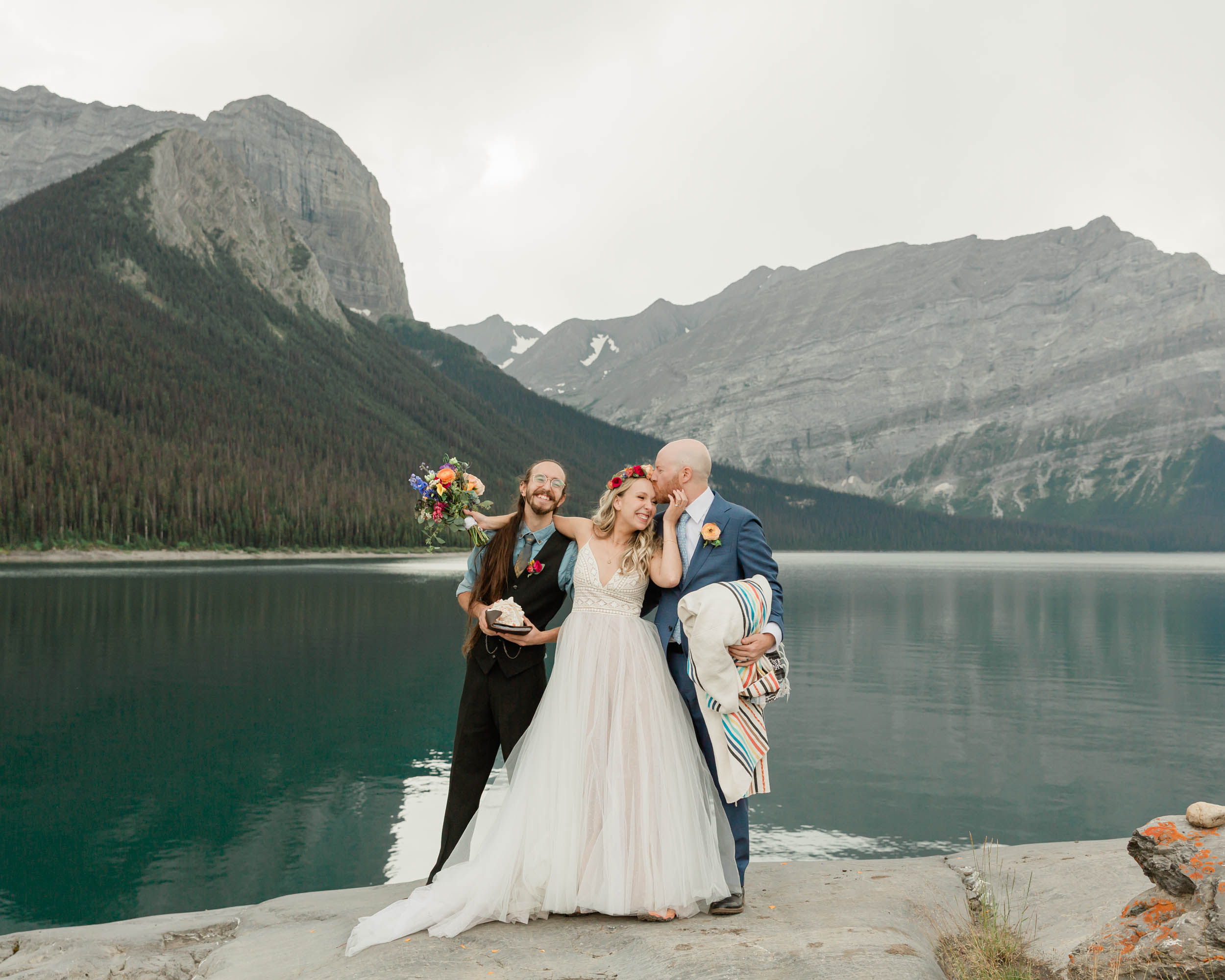 megan, scott and carter hugging and celebrating after their elopement 