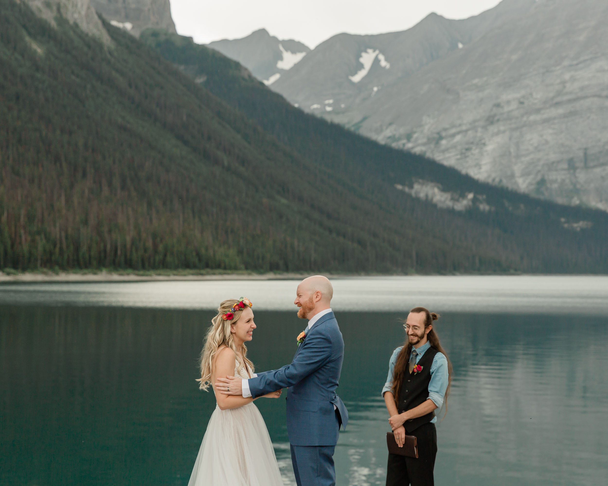 the couple reciting their vows and exchanging rings for their kananaskis mountain elopement ceremony