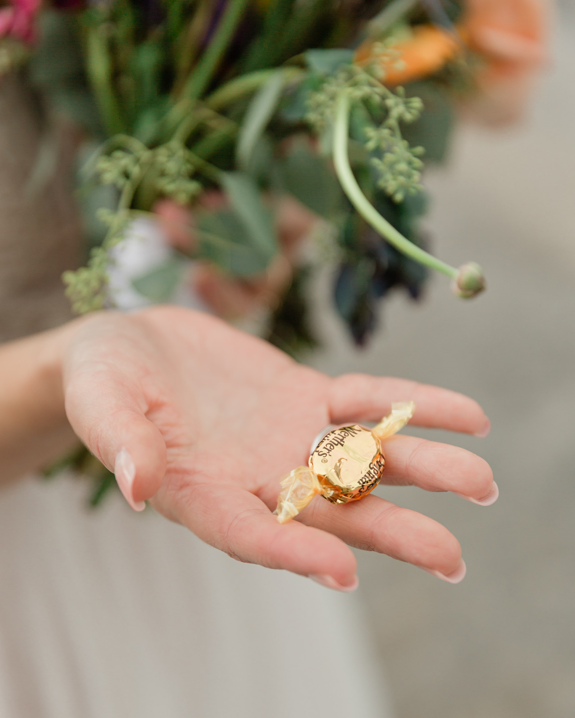 the bride holding a werthers original that she offered to the groom after their ceremony for a treat