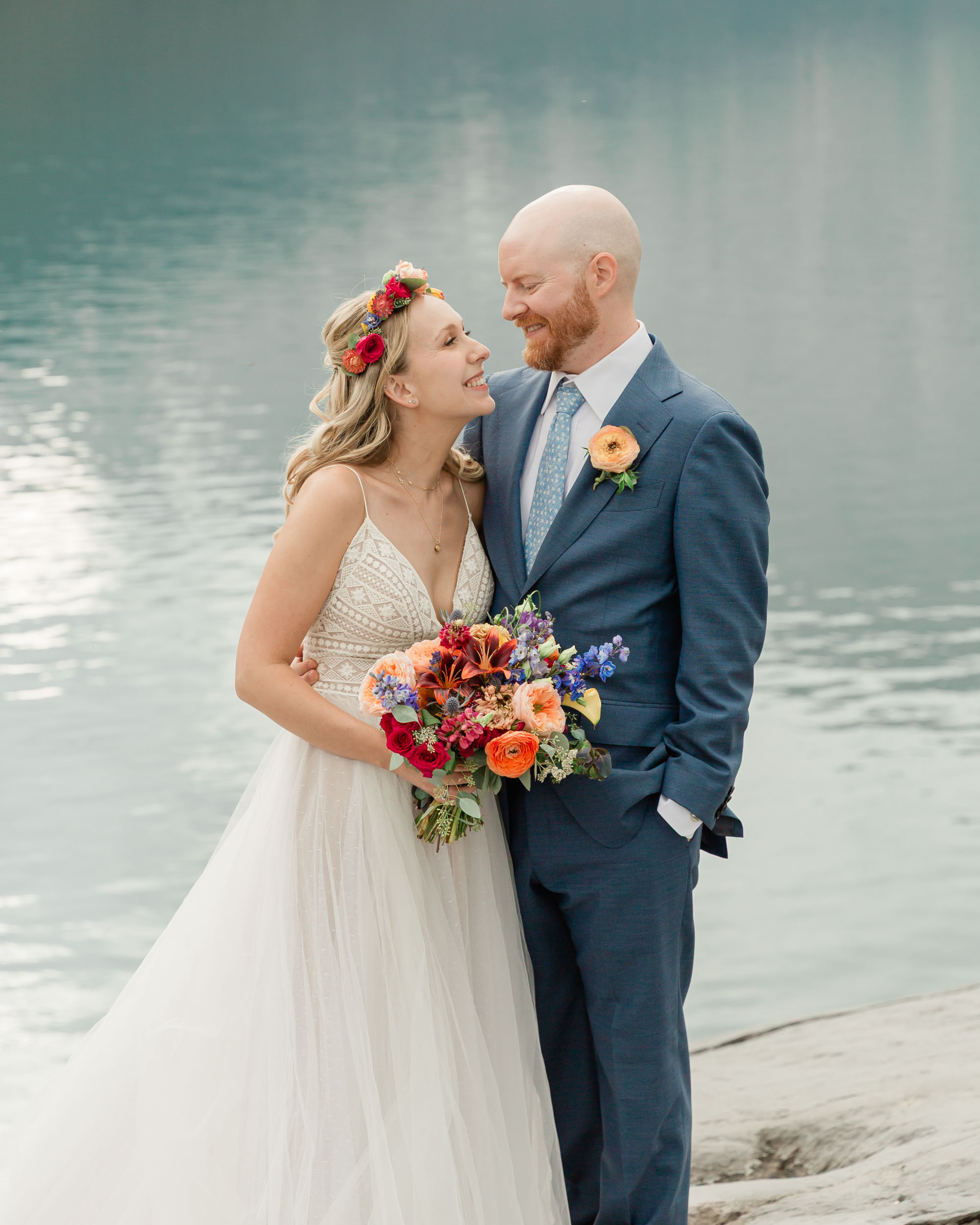 the couple posing for the camera during their mountain wedding near banff