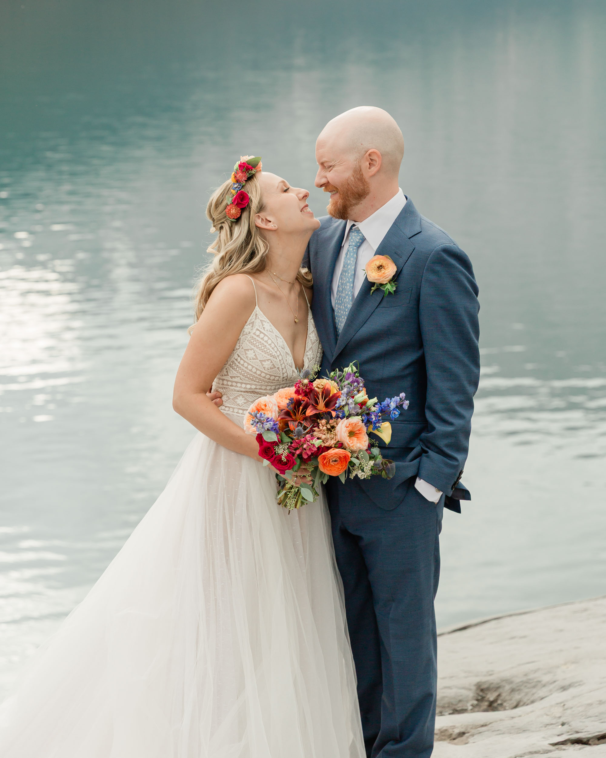the couple posing for the camera during their mountain wedding near banff