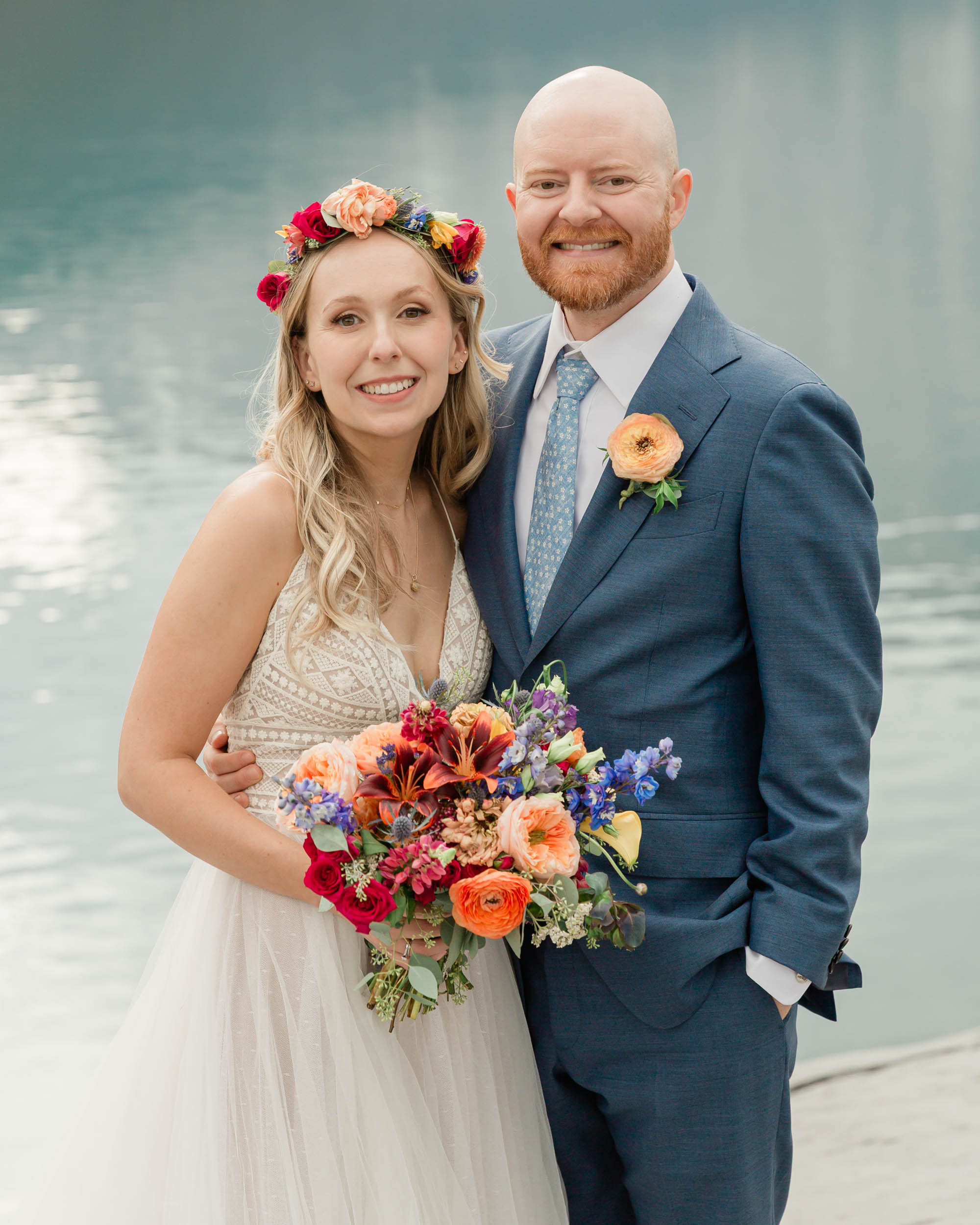 the couple posing for the camera during their mountain wedding near banff