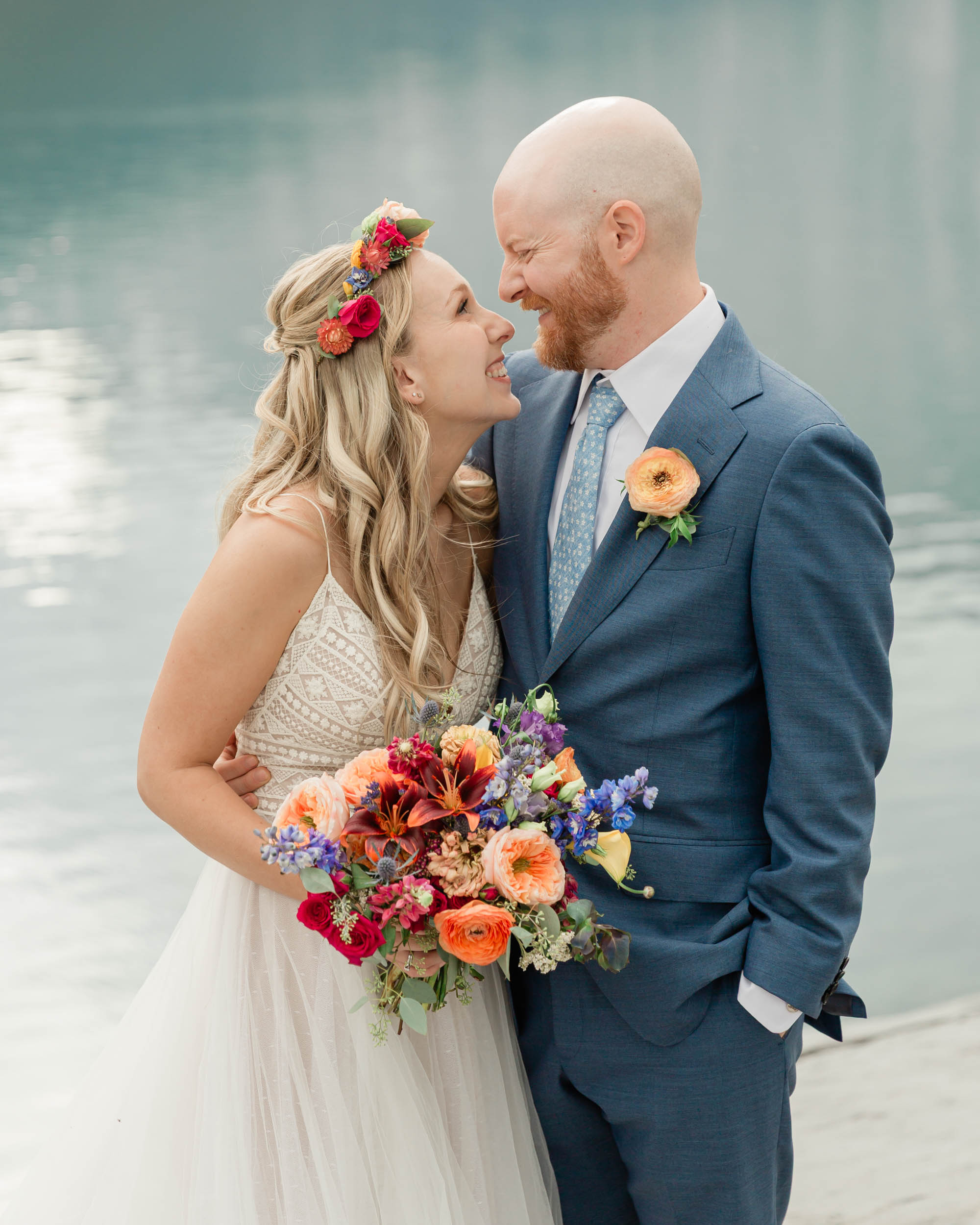 the couple posing for the camera during their mountain wedding near banff